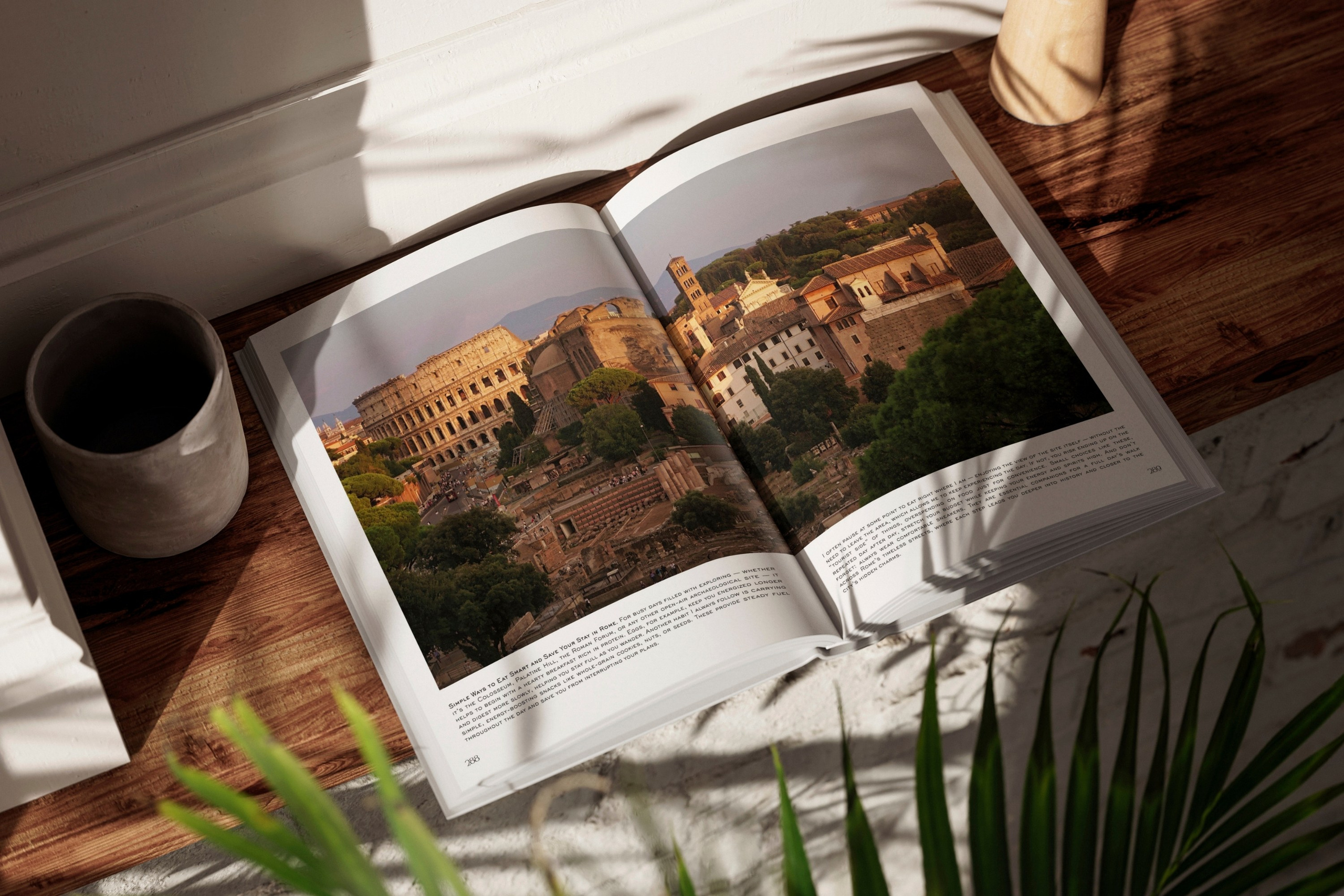 Rome, Italy – Photography Book – Rome — When Light Shapes Form – Open hardcover photography book displayed on a wooden table with a panoramic photograph of the Roman Forum across a two-page spread – Eduardo Bartoli Photography