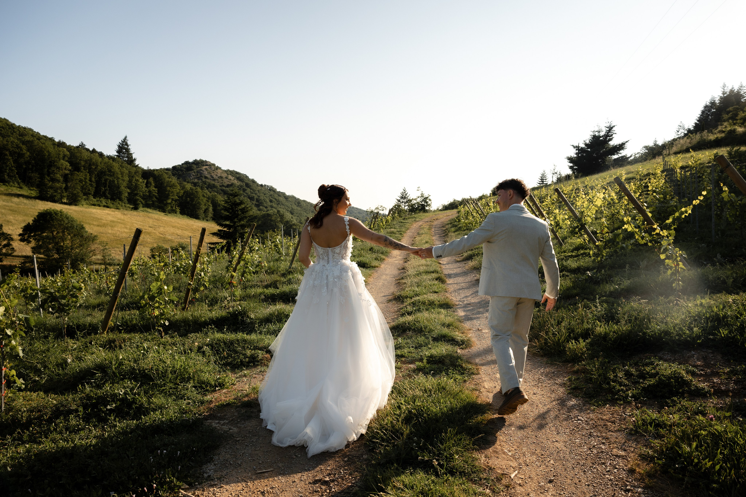 Couple walking through the vineyards at Domaine Merlac at sunset, Southwest France