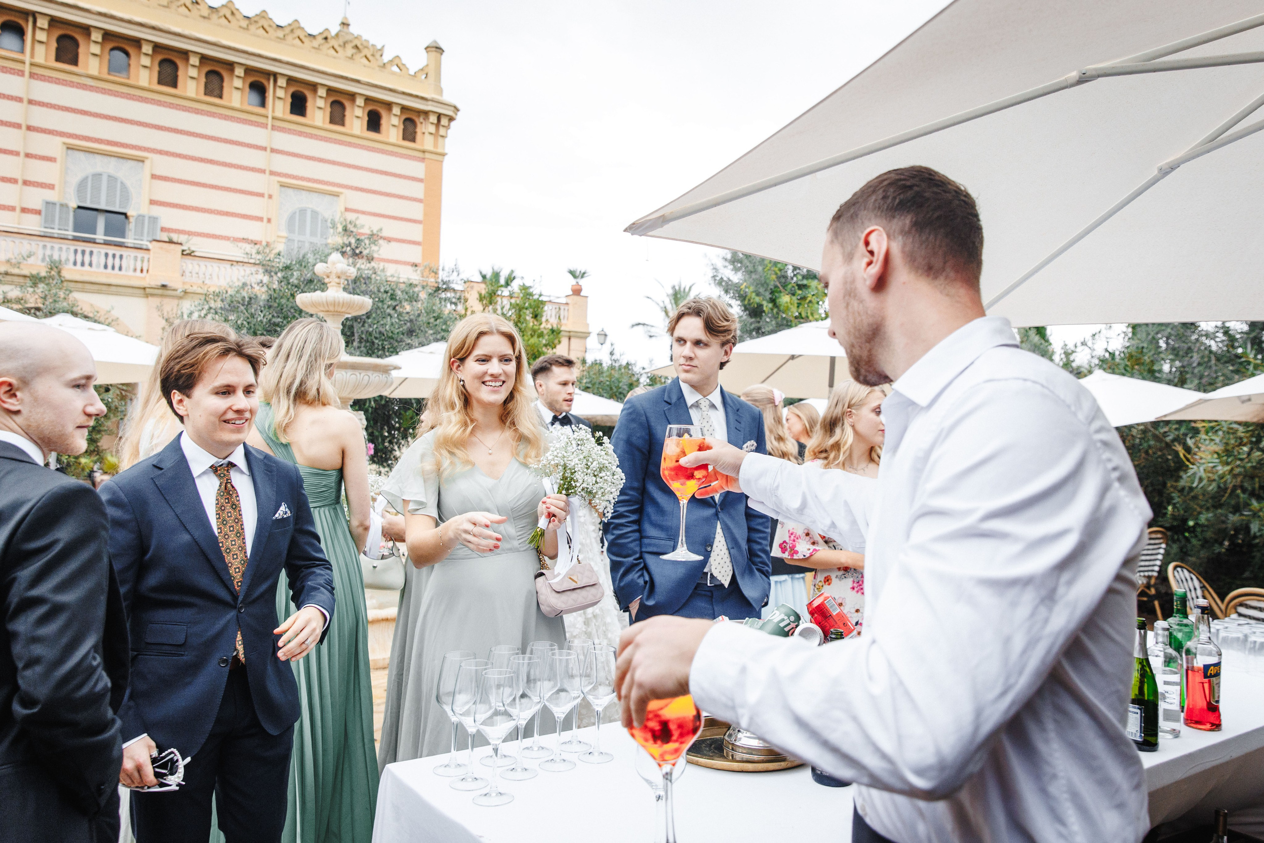 Guests of the destination wedding in Barcelona enjoy the cocktail party before the wedding dinner. 