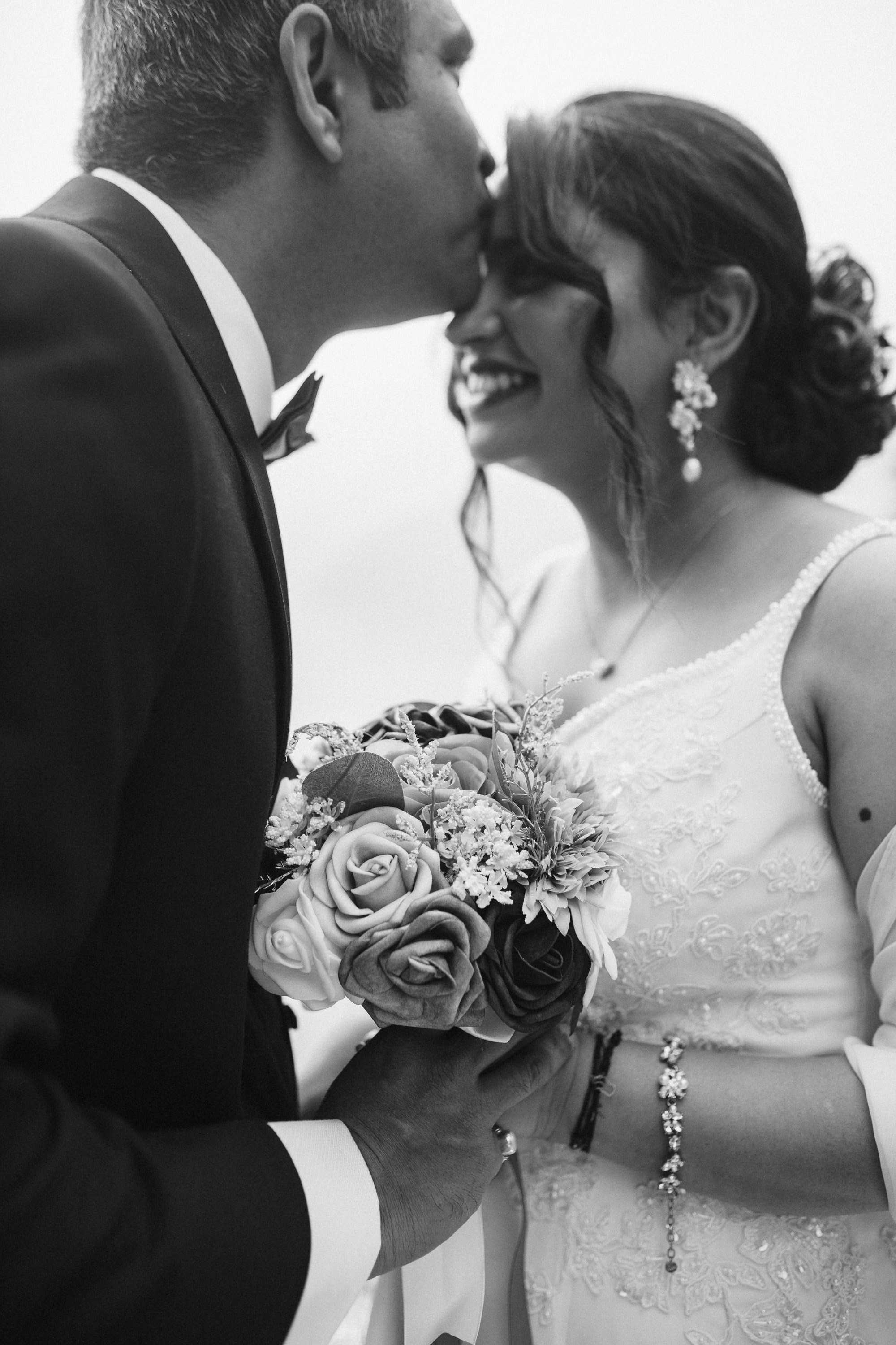 Bride and groom holding hands, black and white romantic photo