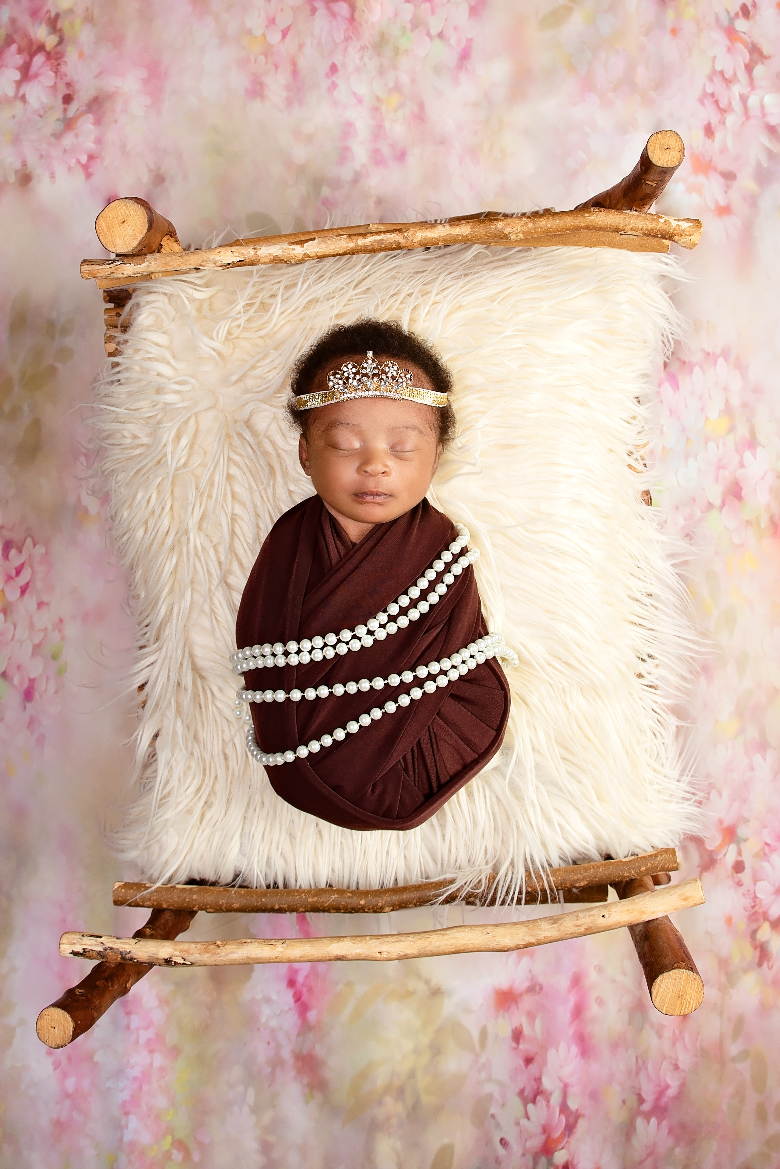 black 10 days baby girl wrapped with pearls on the bed newborn shoot Mombasa Kenya