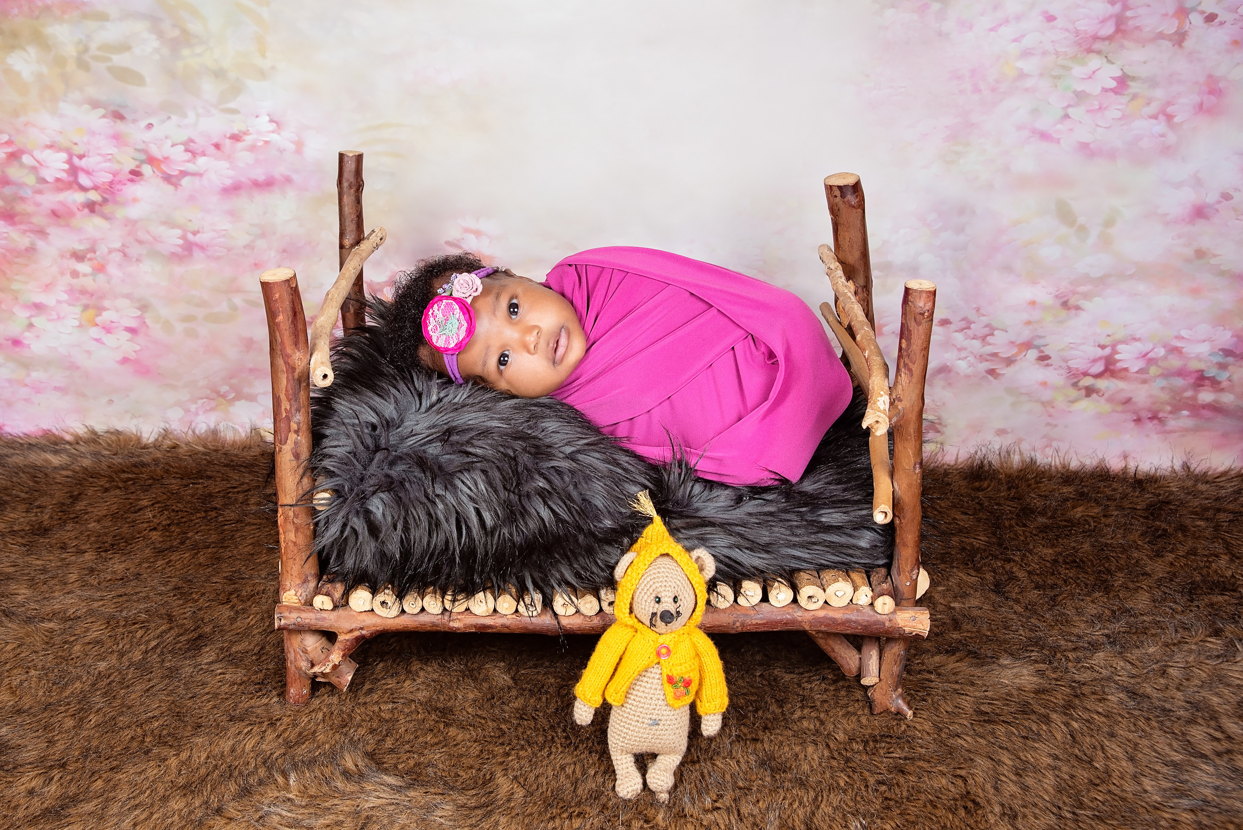 African 3 weeks baby girl laying on the bed photo shoot
