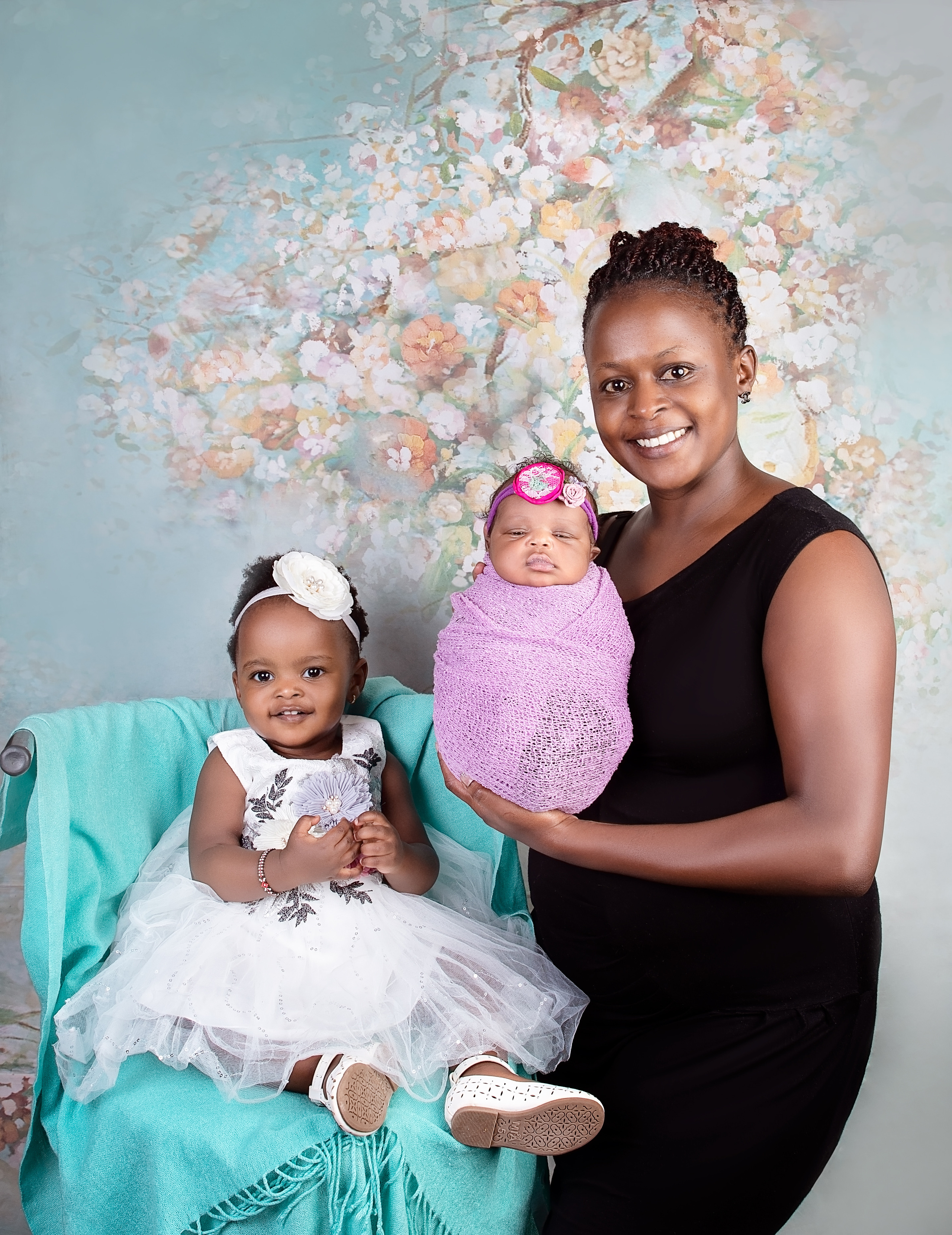 Black Kenyan family with mother newborn baby girl and sibling sister photo shoot Nairobi Kenya