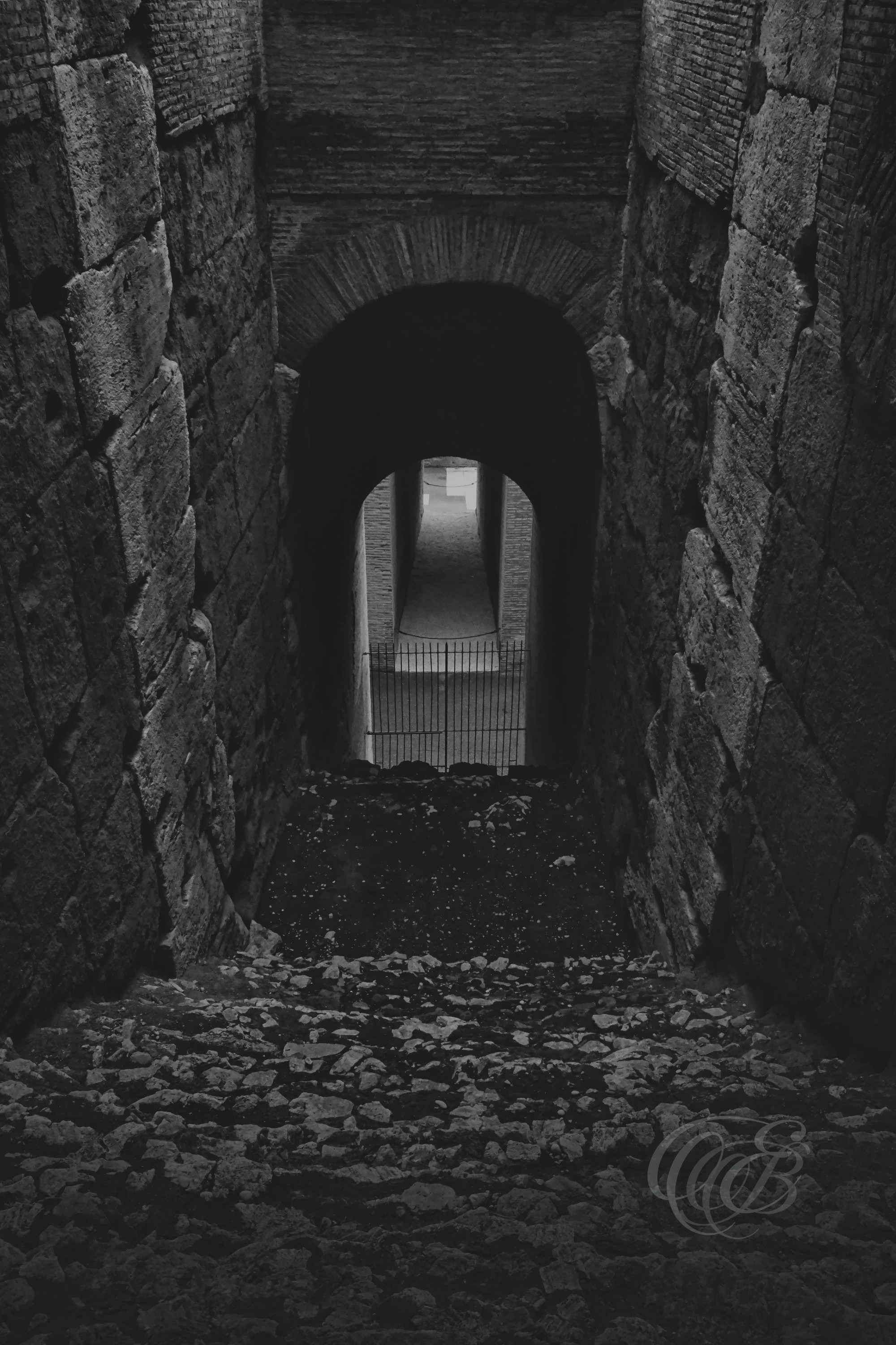 Rome, Italy — Arched Staircase Inside the Colosseum — Eduardo Bartoli Photography — Black and white photograph of an interior staircase and vaulted archways within the Colosseum, highlighting Roman engineering, stone textures, and historic passageways in Rome, Italy — Eduardo Bartoli Photography.