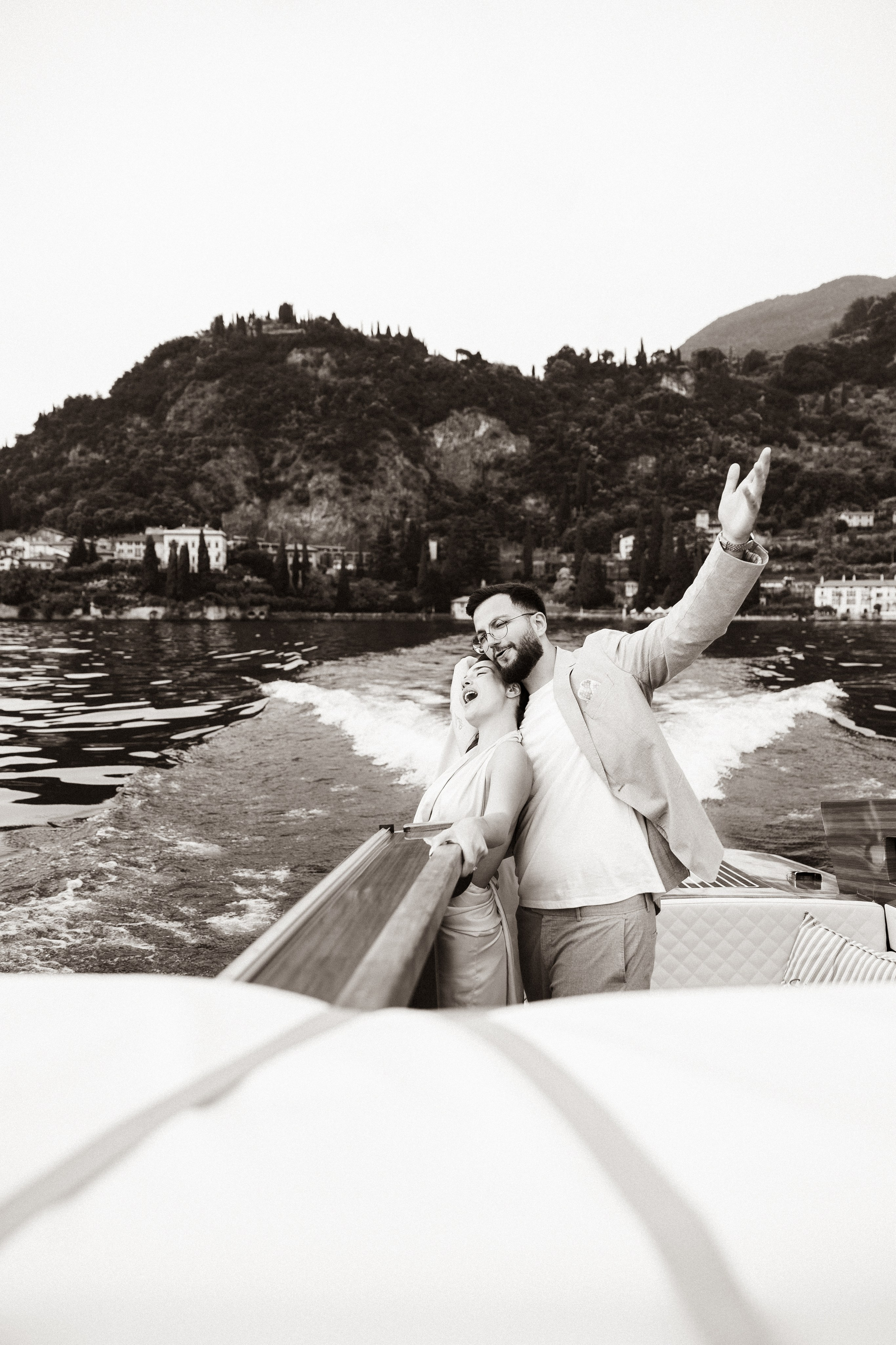 Couple enjoying a romantic boat ride across Lake Como in Italy