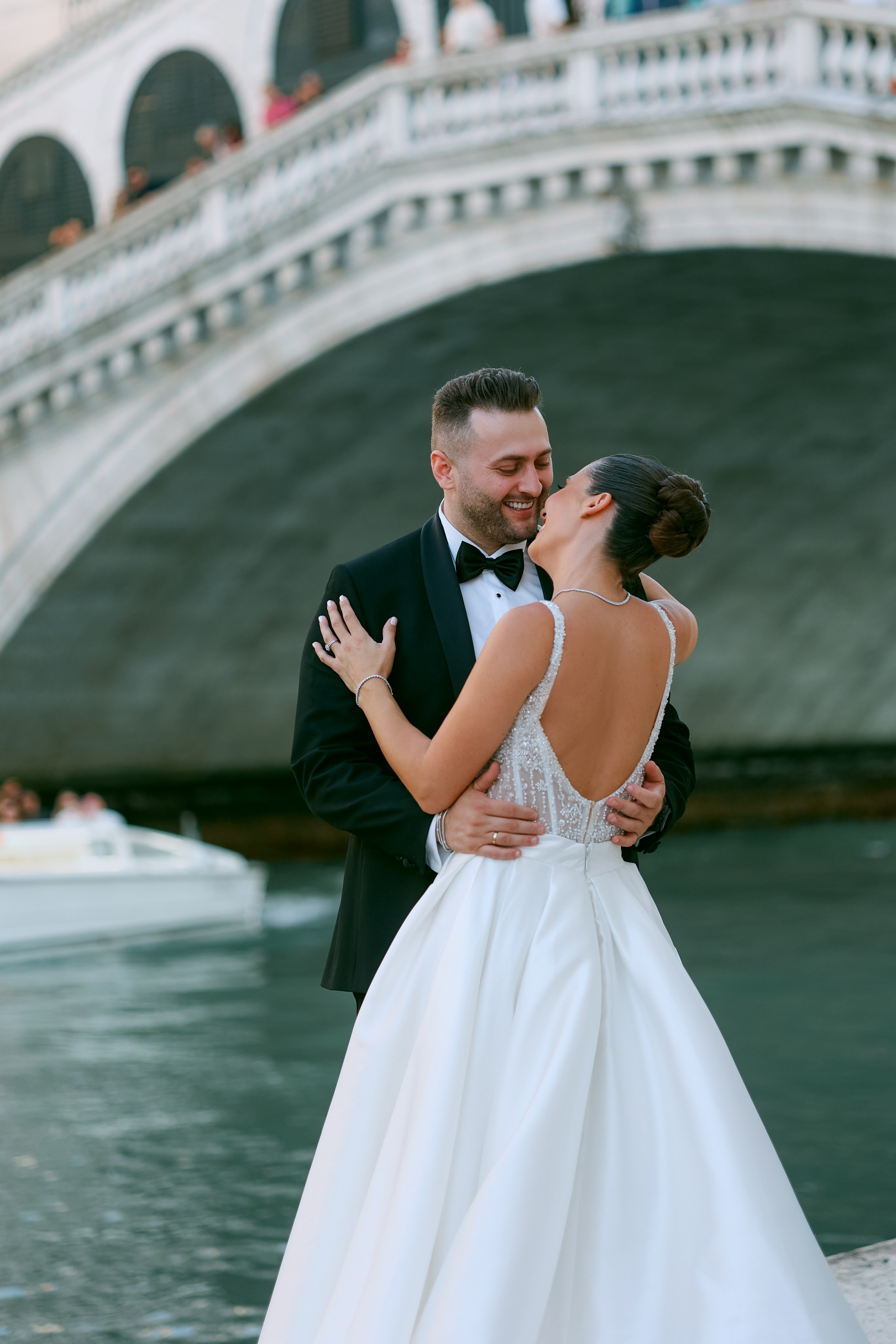 Romantic moment of a wedding couple by the Rialto Bridge on the canals of Venice