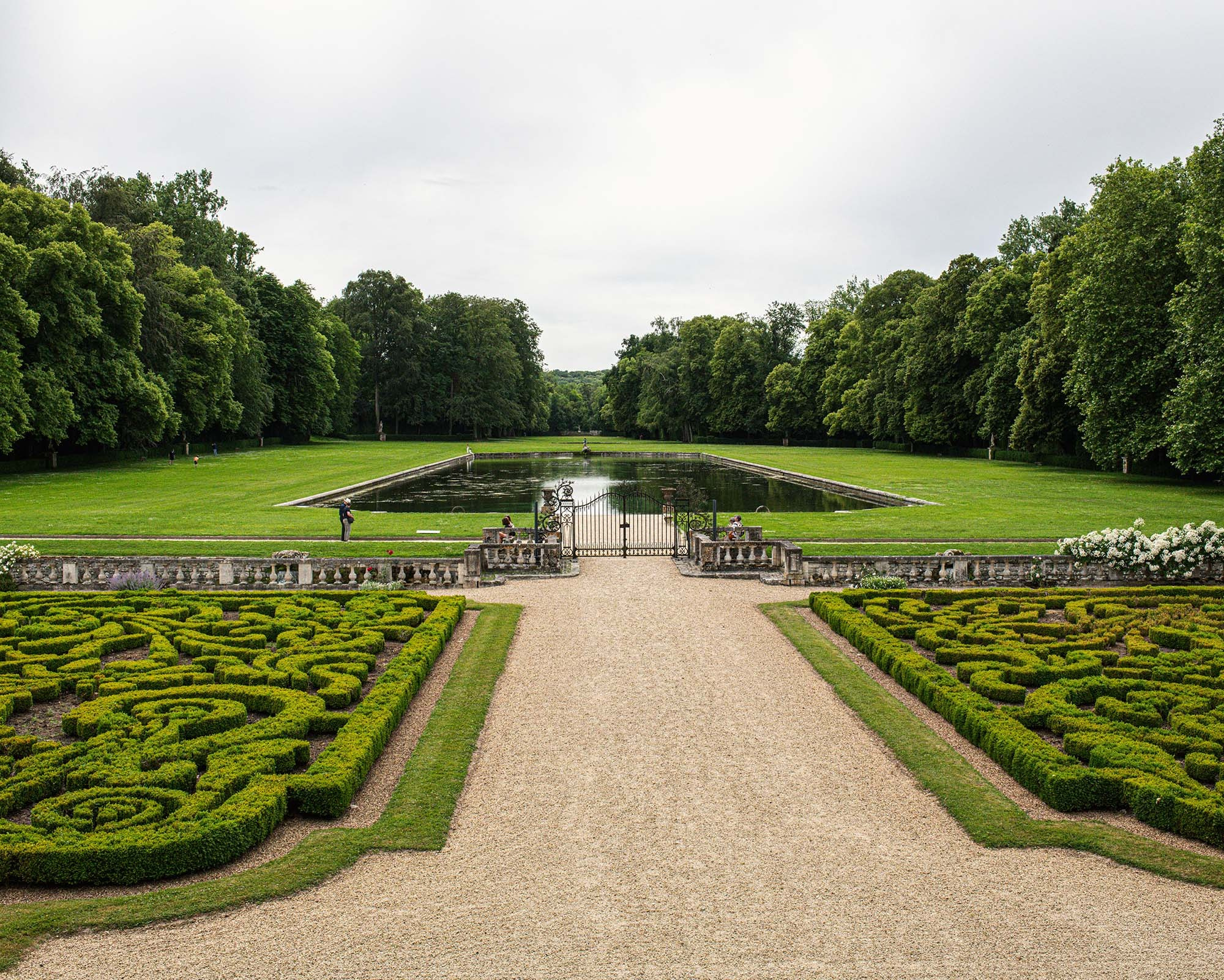 French formal gardens and reflecting pool at Château de Courances near Paris, France