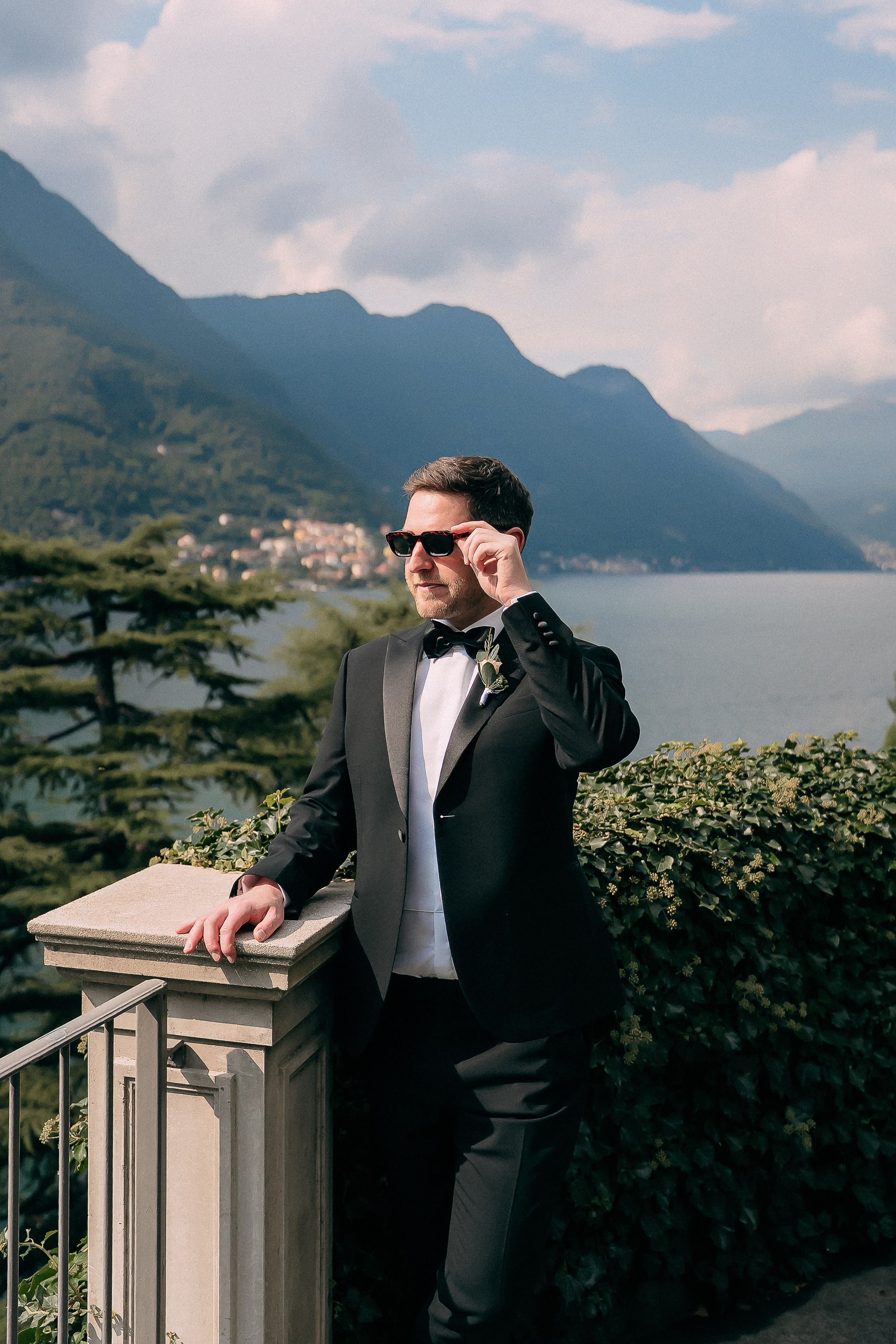 Groom portrait overlooking Lake Como from Villa Lario, Italy
