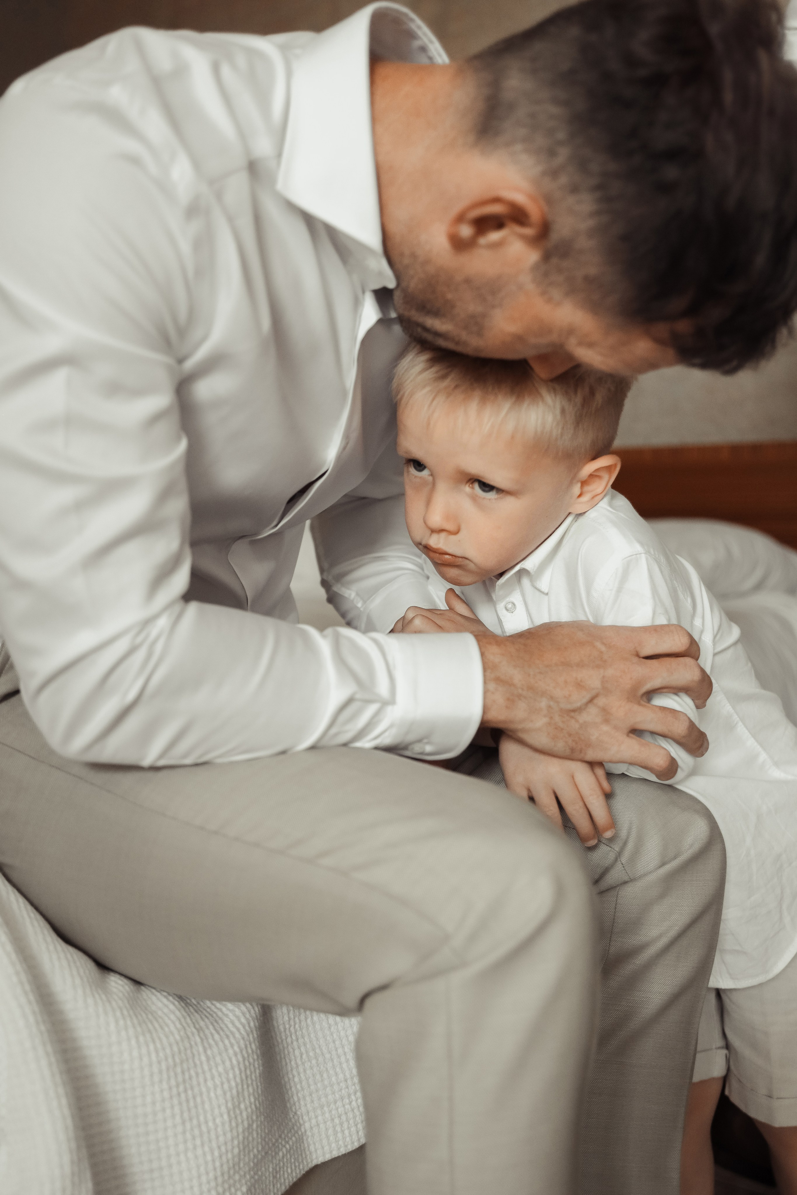 Groom is kissing his son as getting ready for the wedding. Rhodes, Greece