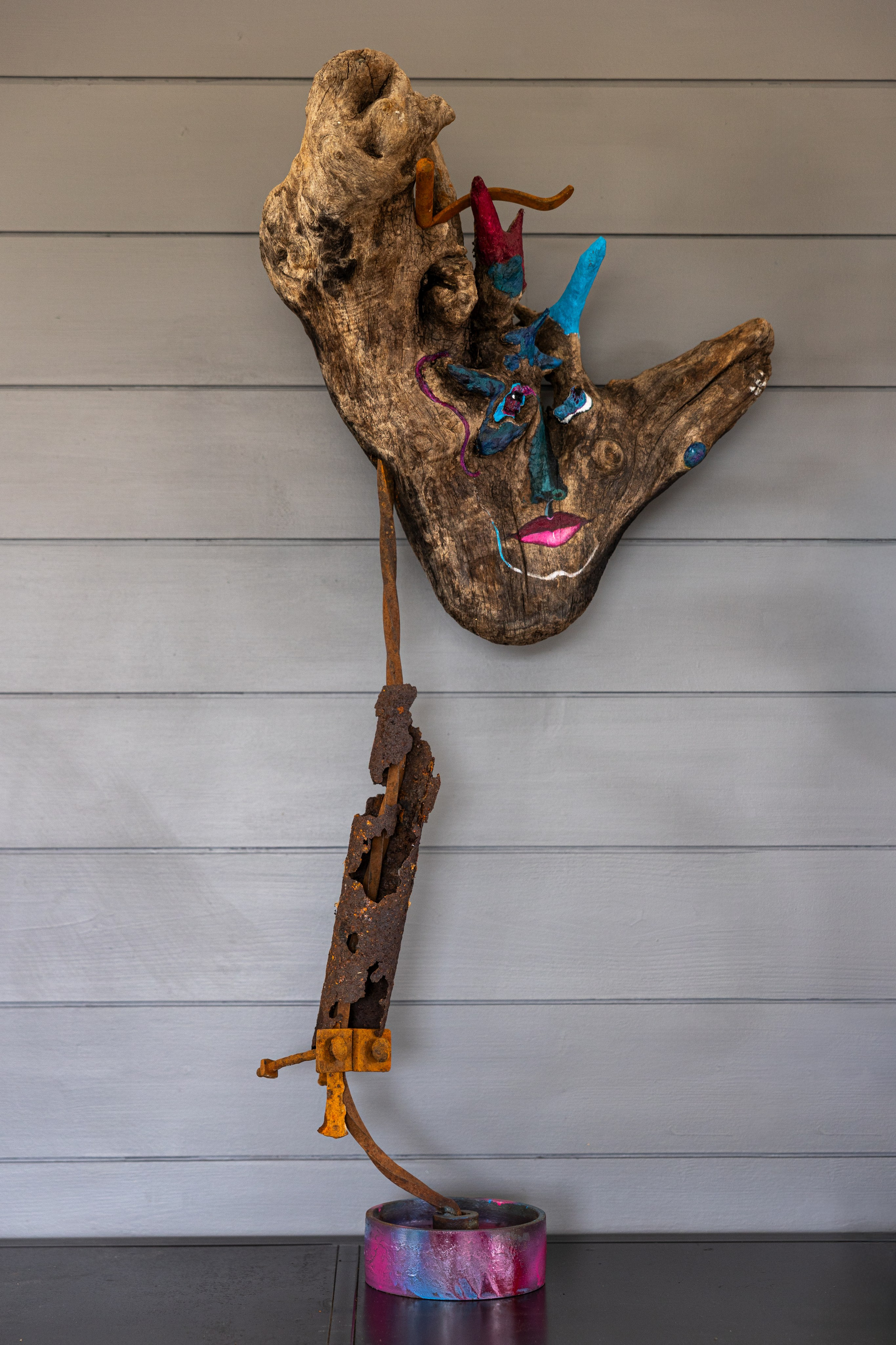 Heavy painted wood head on a metallic stick 