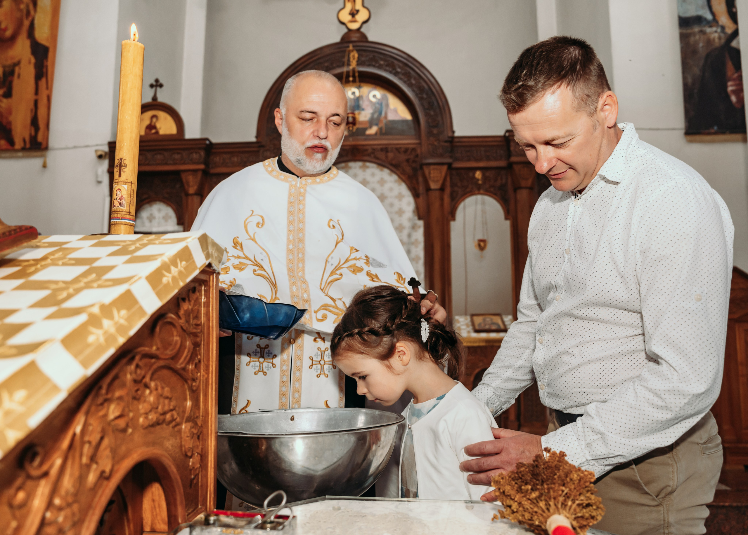 Kum i svestenik krste devojcicu u beogradu