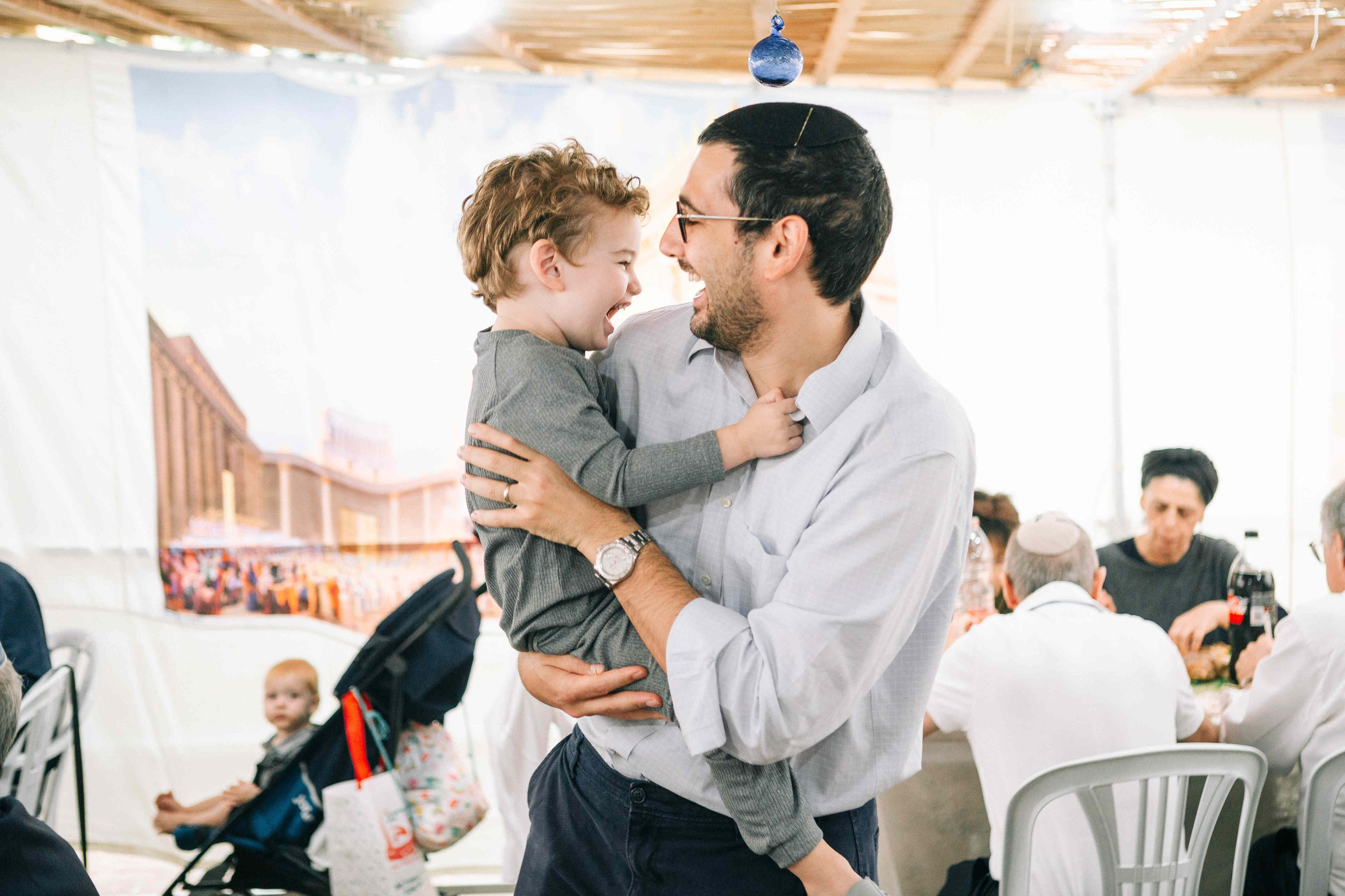 BRITH MILA IN THE SMALL SYNAGOGUE. PHOTOGRAPHER IN ISRAEL