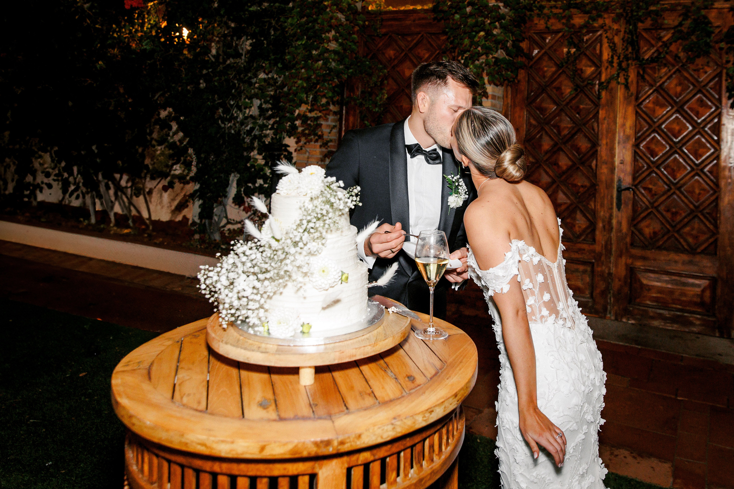 Bride and groom, during the cake-cutting ceremony at a Barcelona wedding, share in the joy