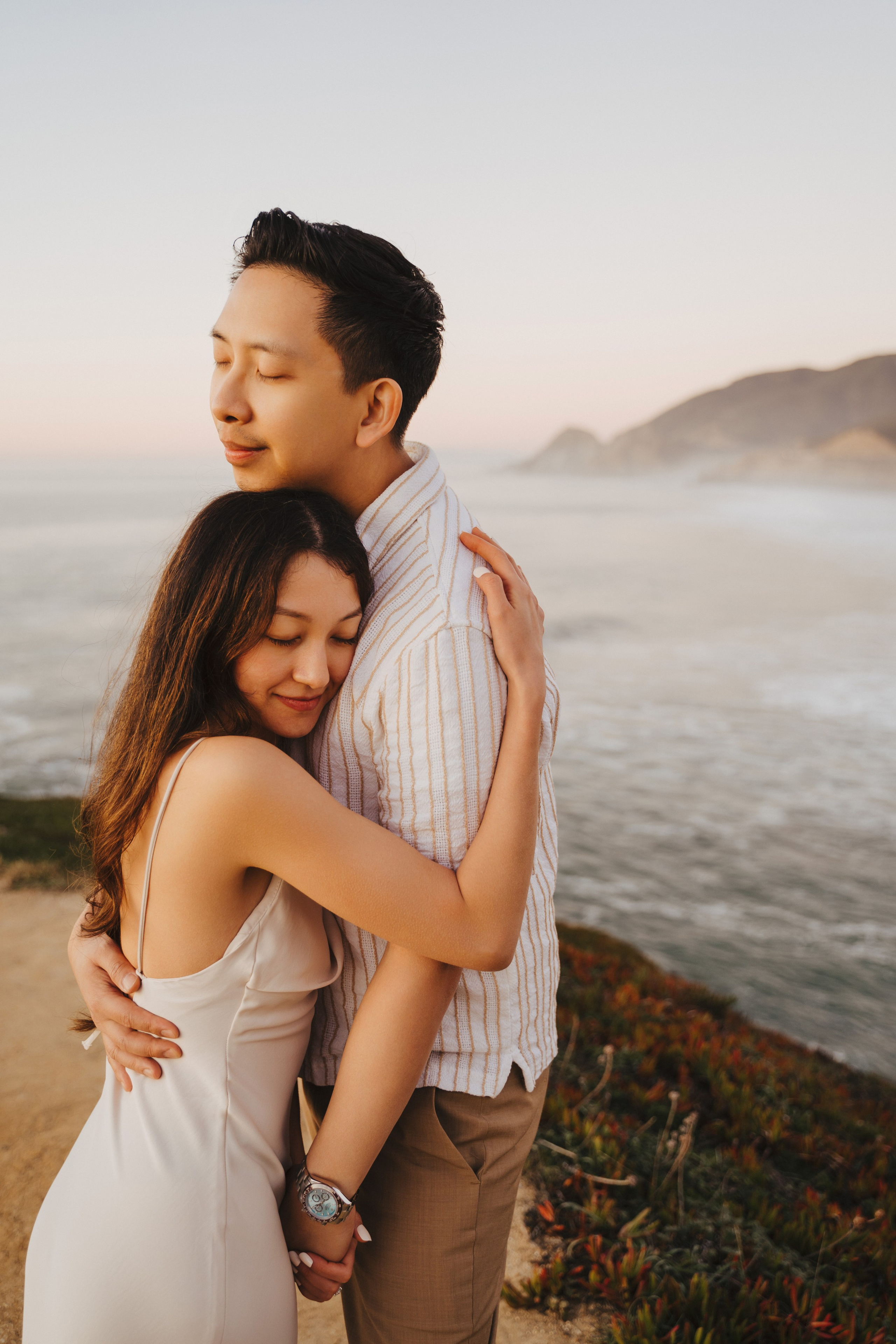 A photo shoot on the San Francisco beach at sunset. Engagement session. 
