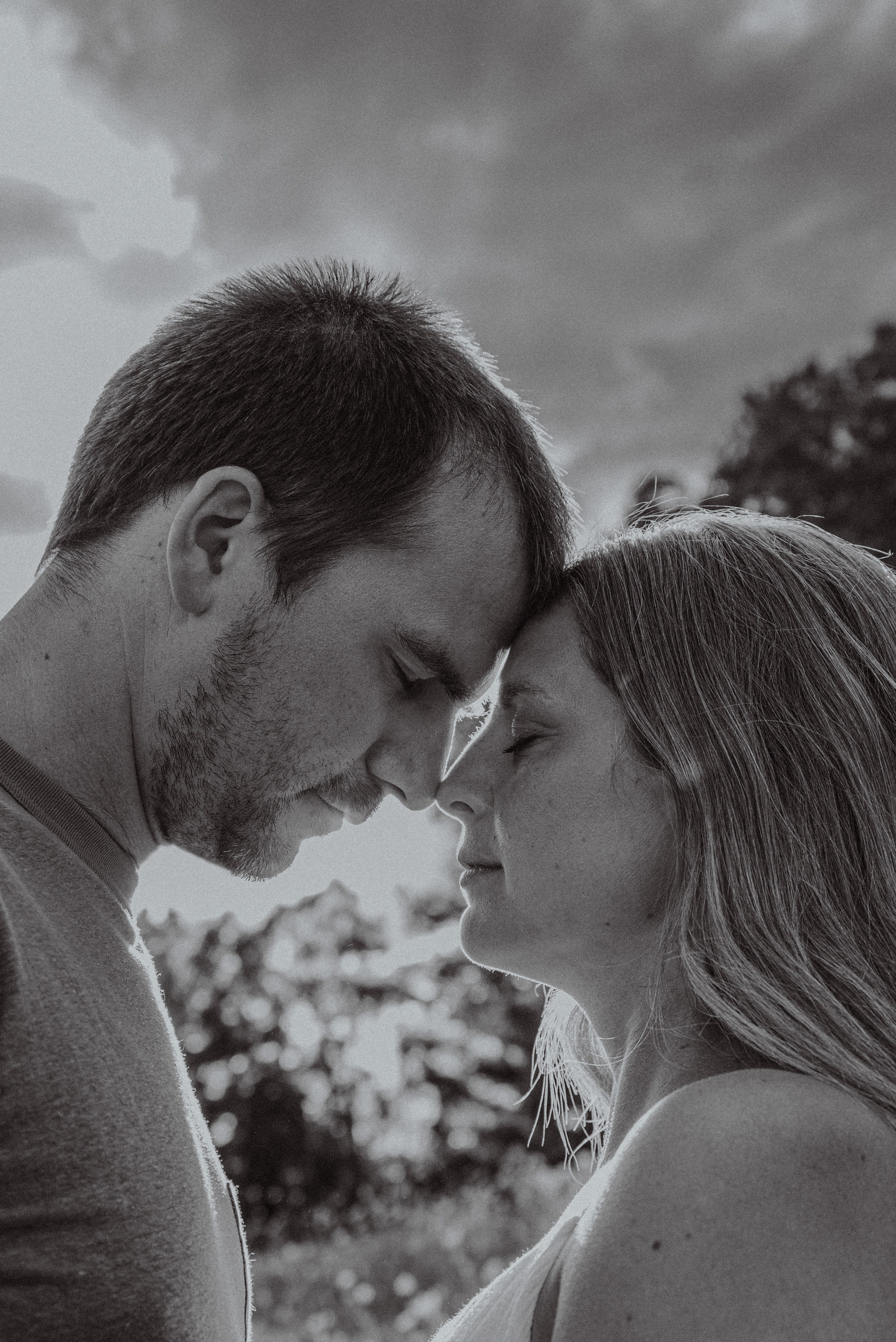 "Surprise proposal in Shawano, capturing the emotional reaction of a couple by a lakeside at sunset.