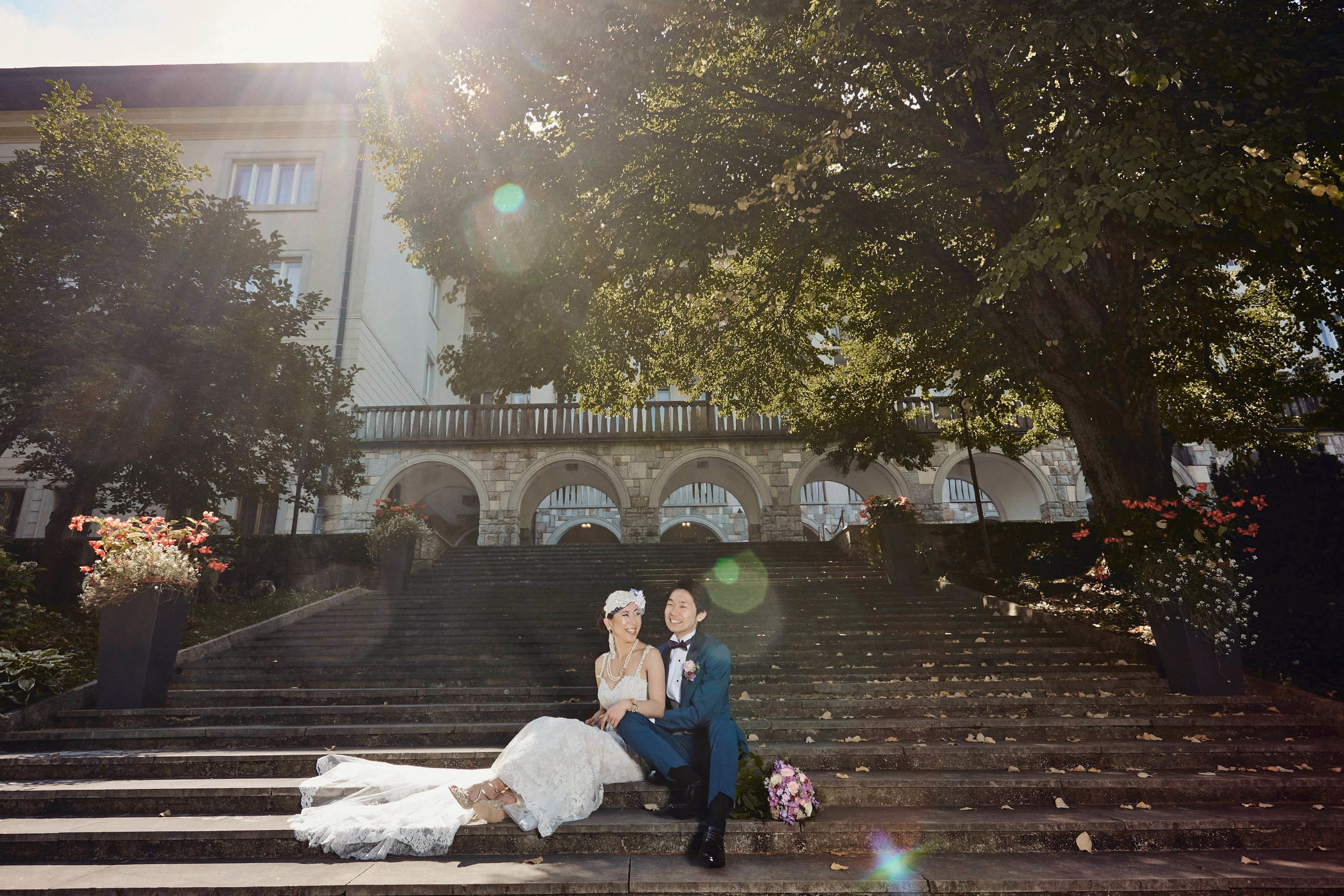 Couple sitting peacefully on historic Vila Bled steps awaiting pletna.