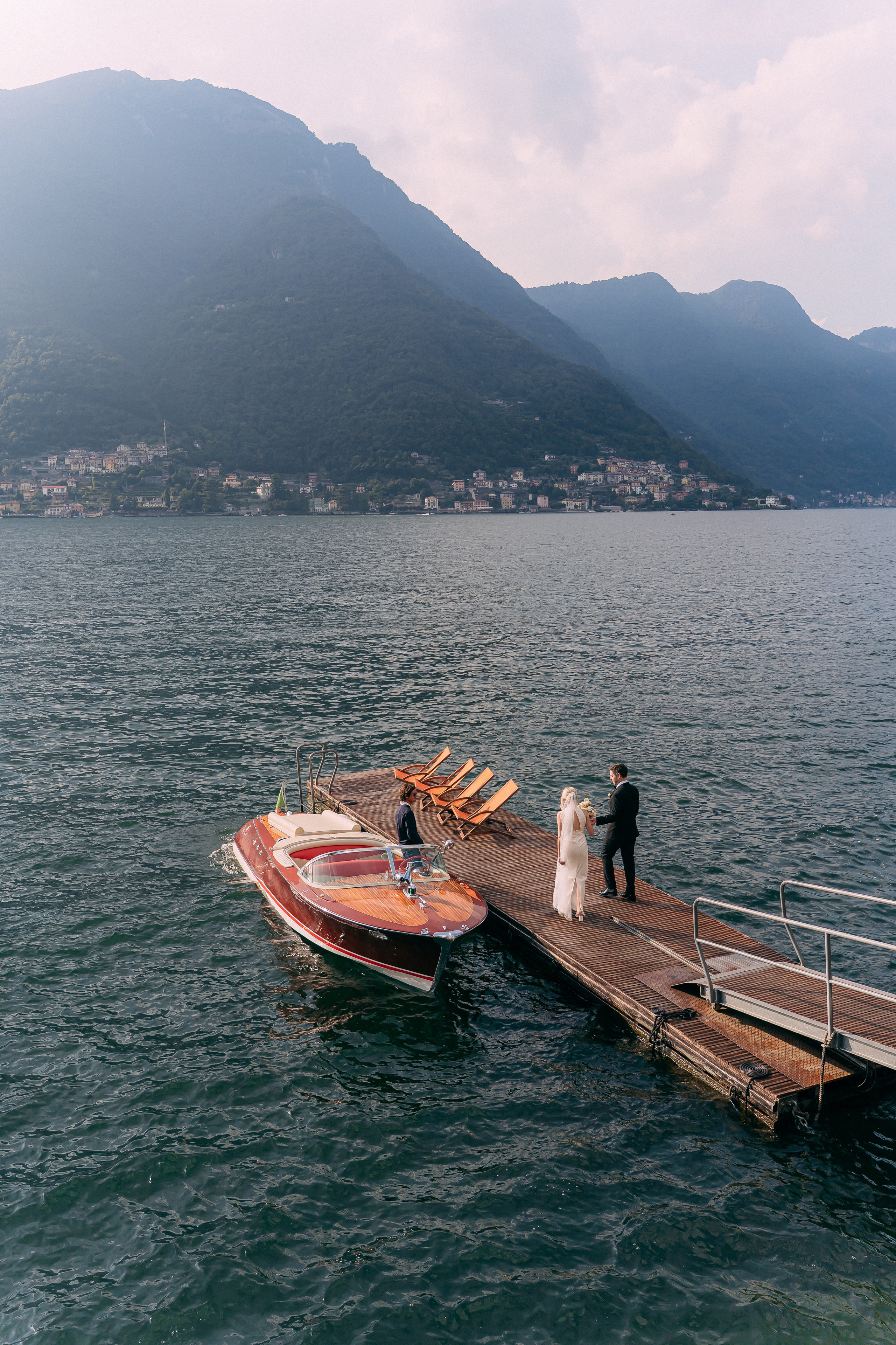 Vintage wooden boat docked on Lake Como near Villa Lario, Italy
