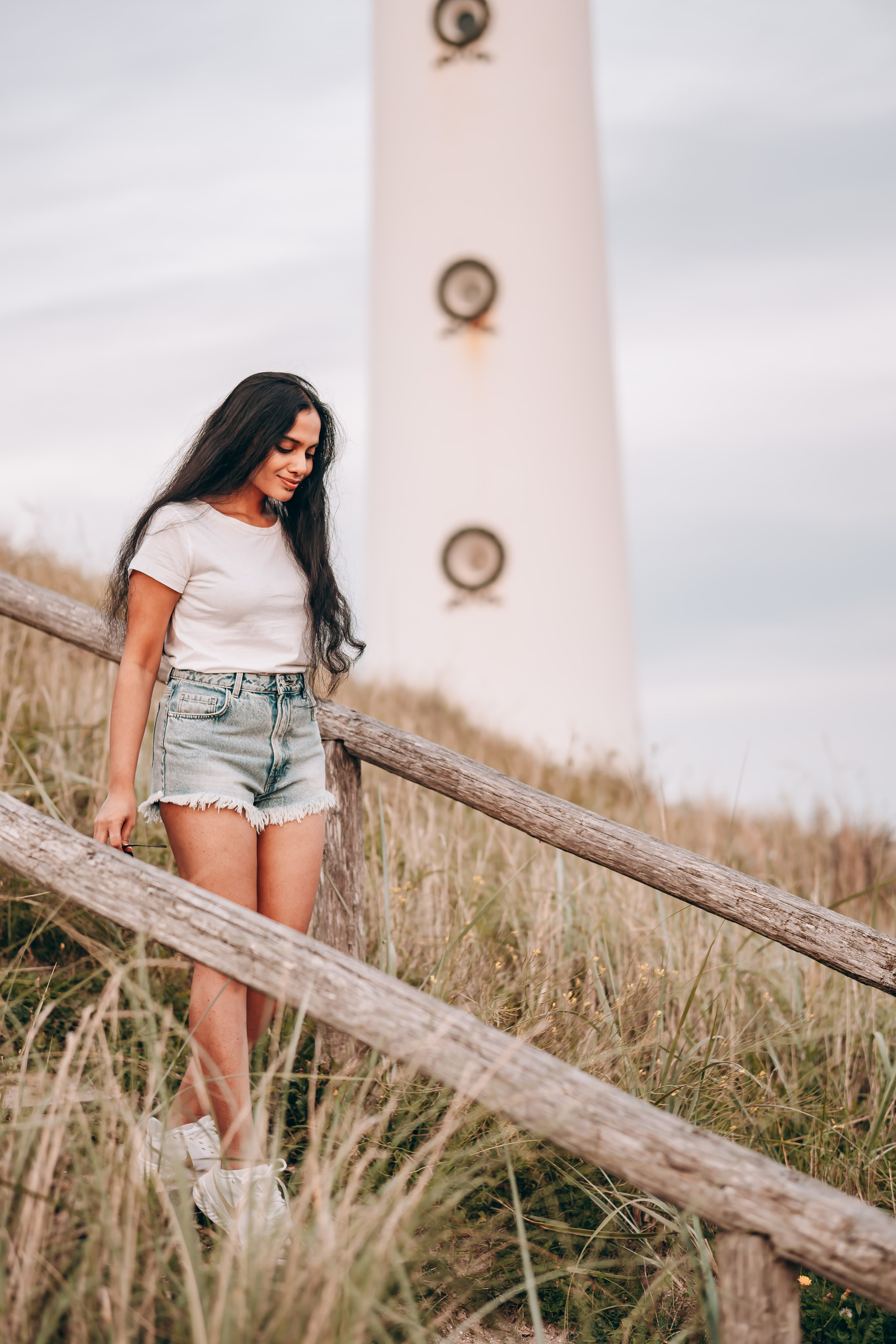 Woman standing in front of a lighthouse in the Netherlands