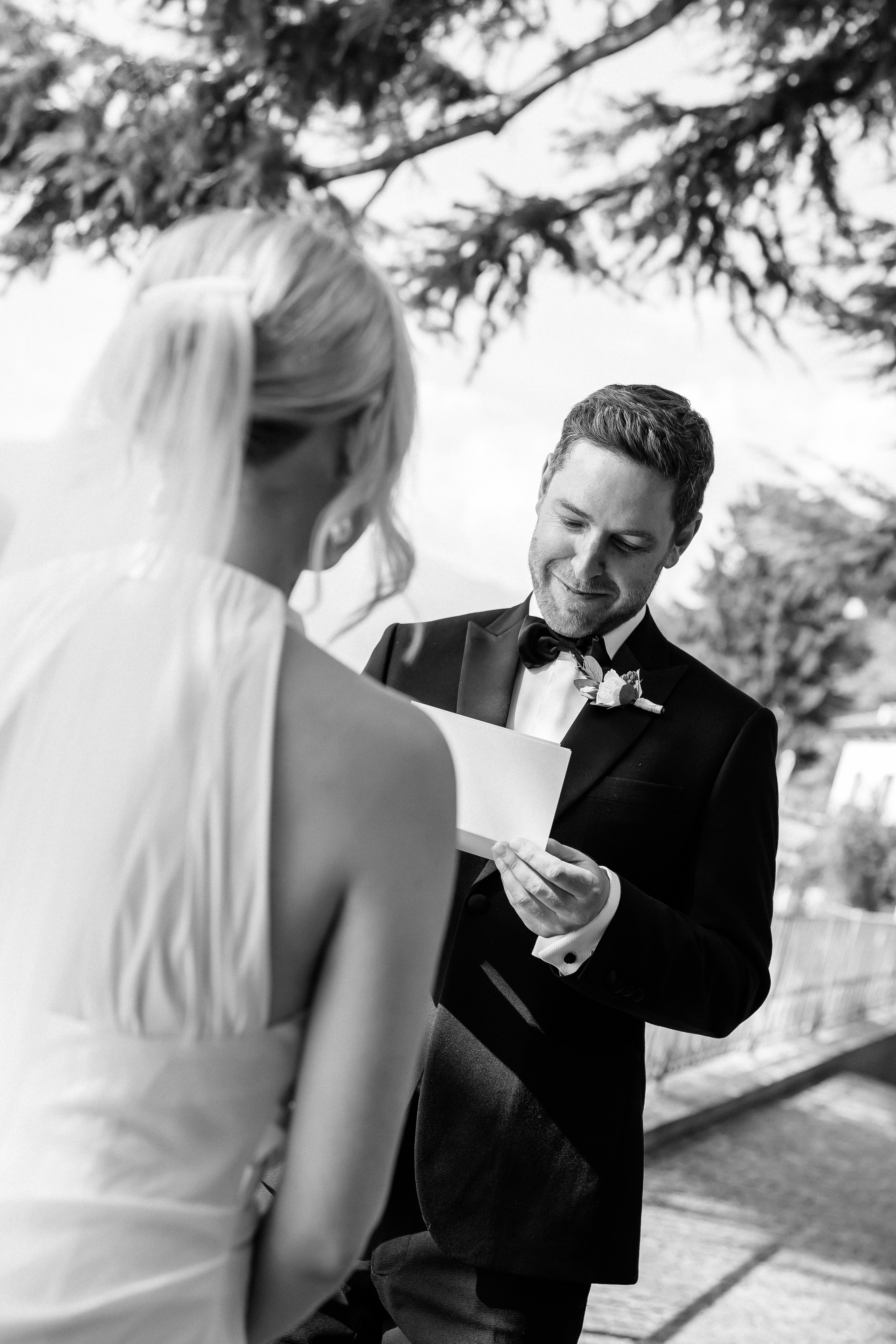 Bride and groom sharing a romantic moment under the trees at Villa Lario, Lake Como, Italy