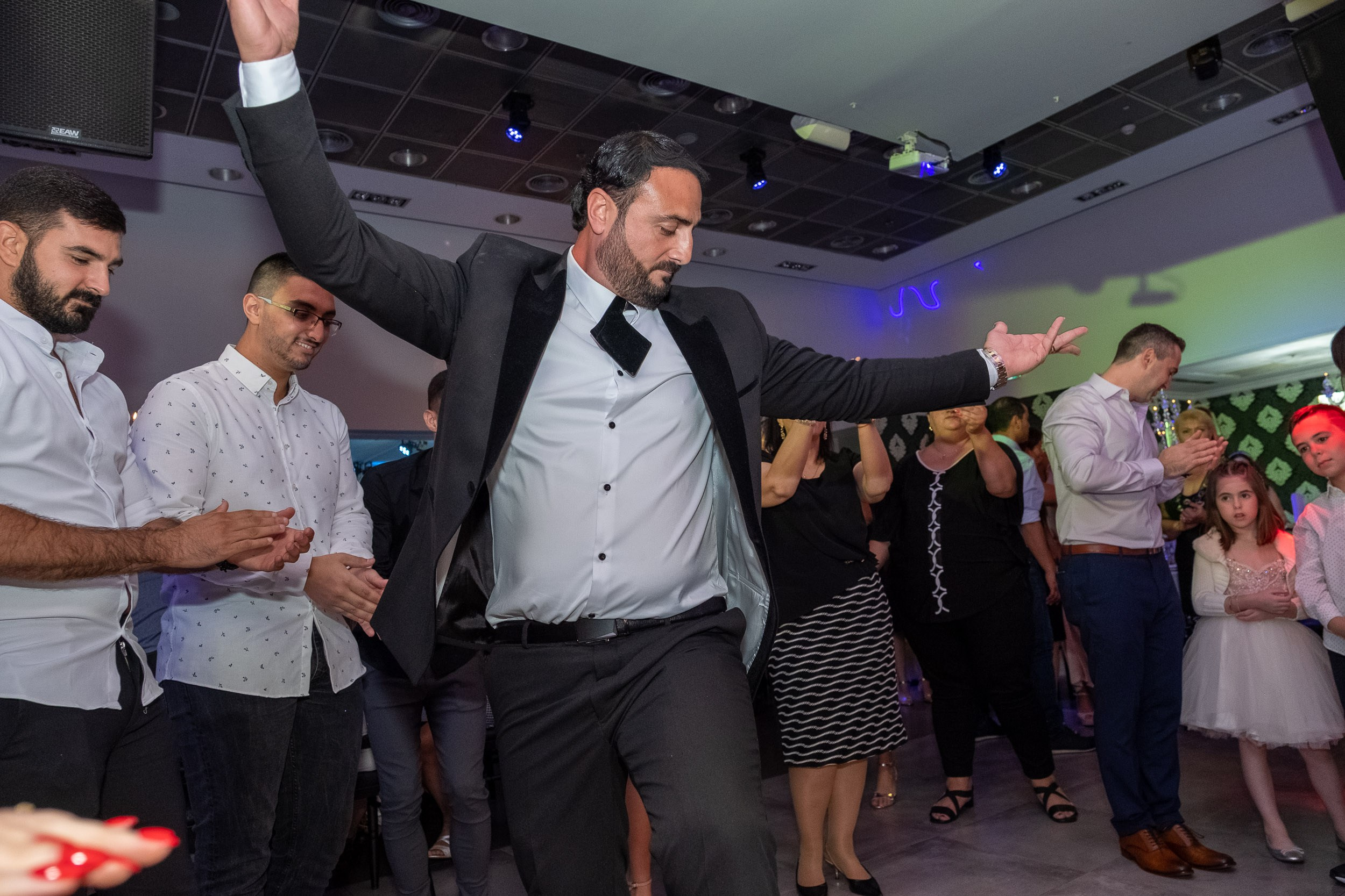 Emil dances with friends during the wedding reception