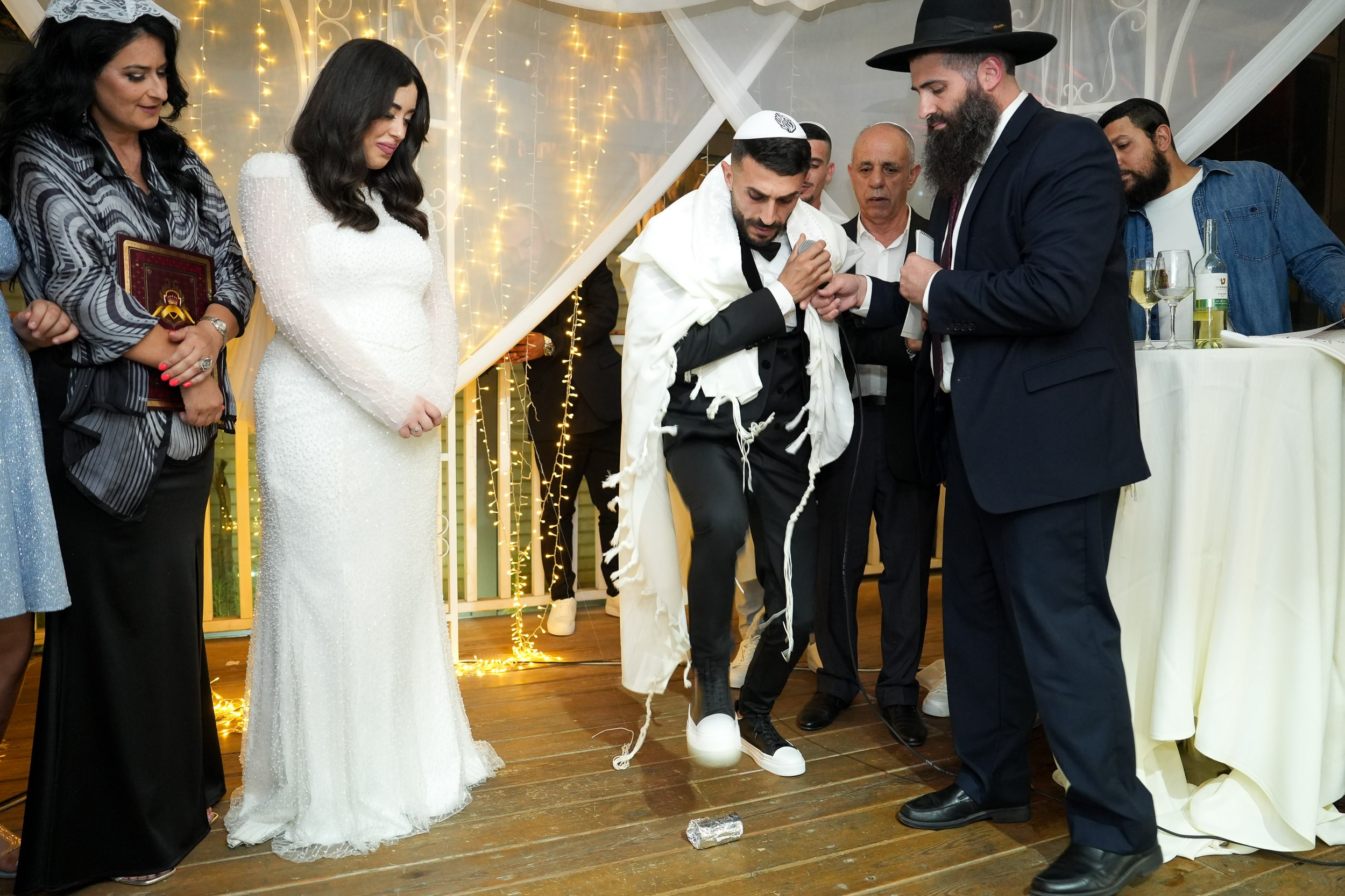 Groom Shimon stepping to break the glass at the end of the Chuppah ceremony at 88 Event Garden in Emek Hefer, Israel