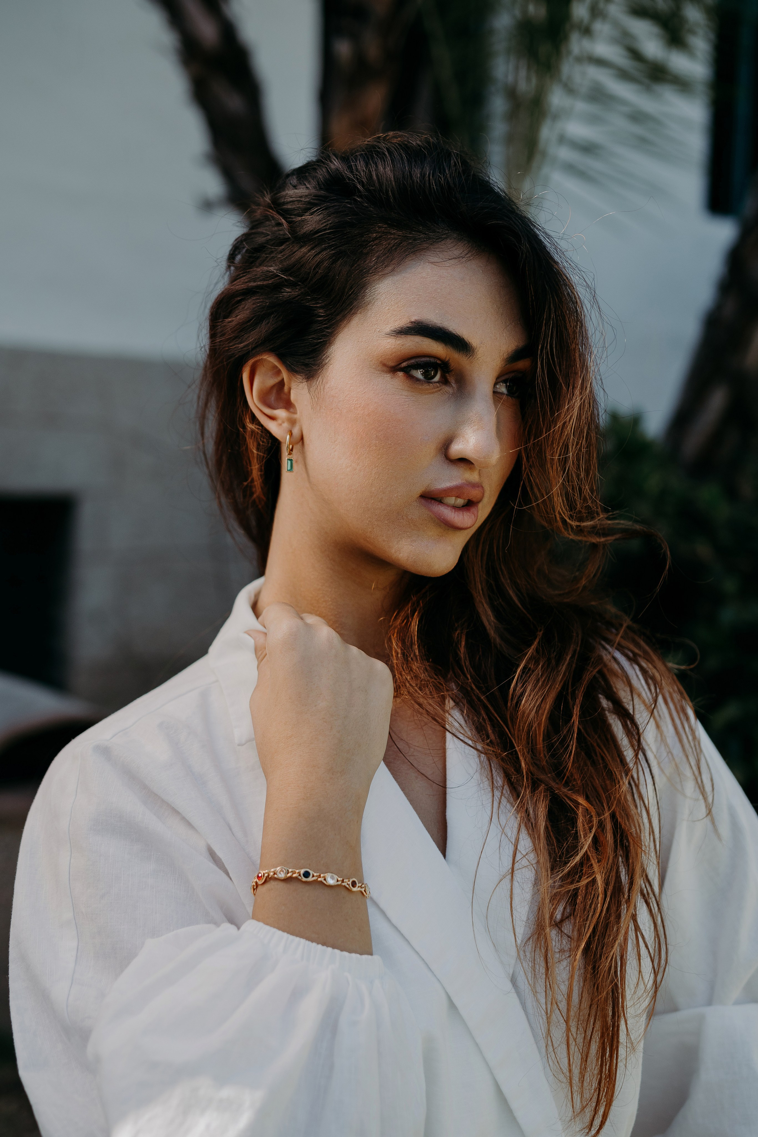 Portrait of a model styled in gold accessories, capturing timeless beauty.