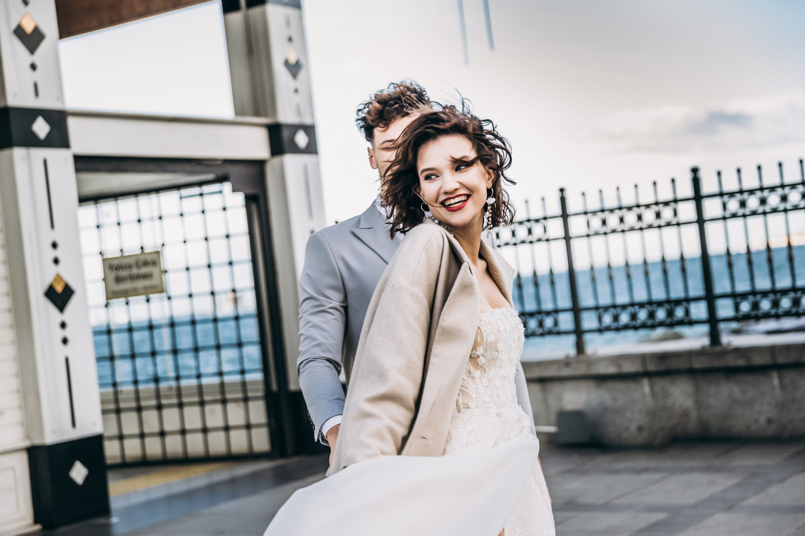 Bride and groom walking through Istanbul market square, timeless wedding photography Europe.