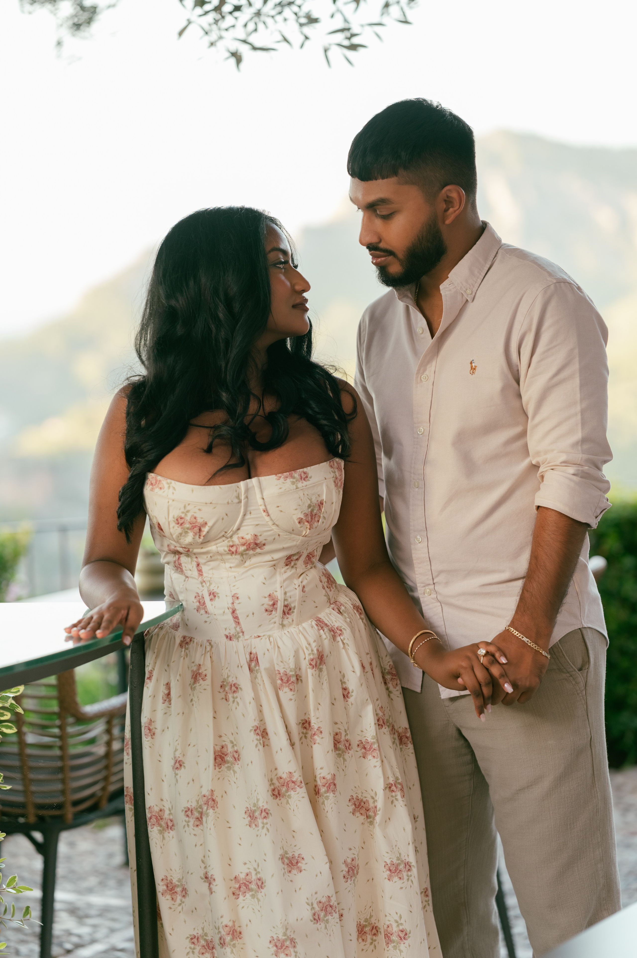 A newly engaged couple holding hands and looking at each other near Sóller.