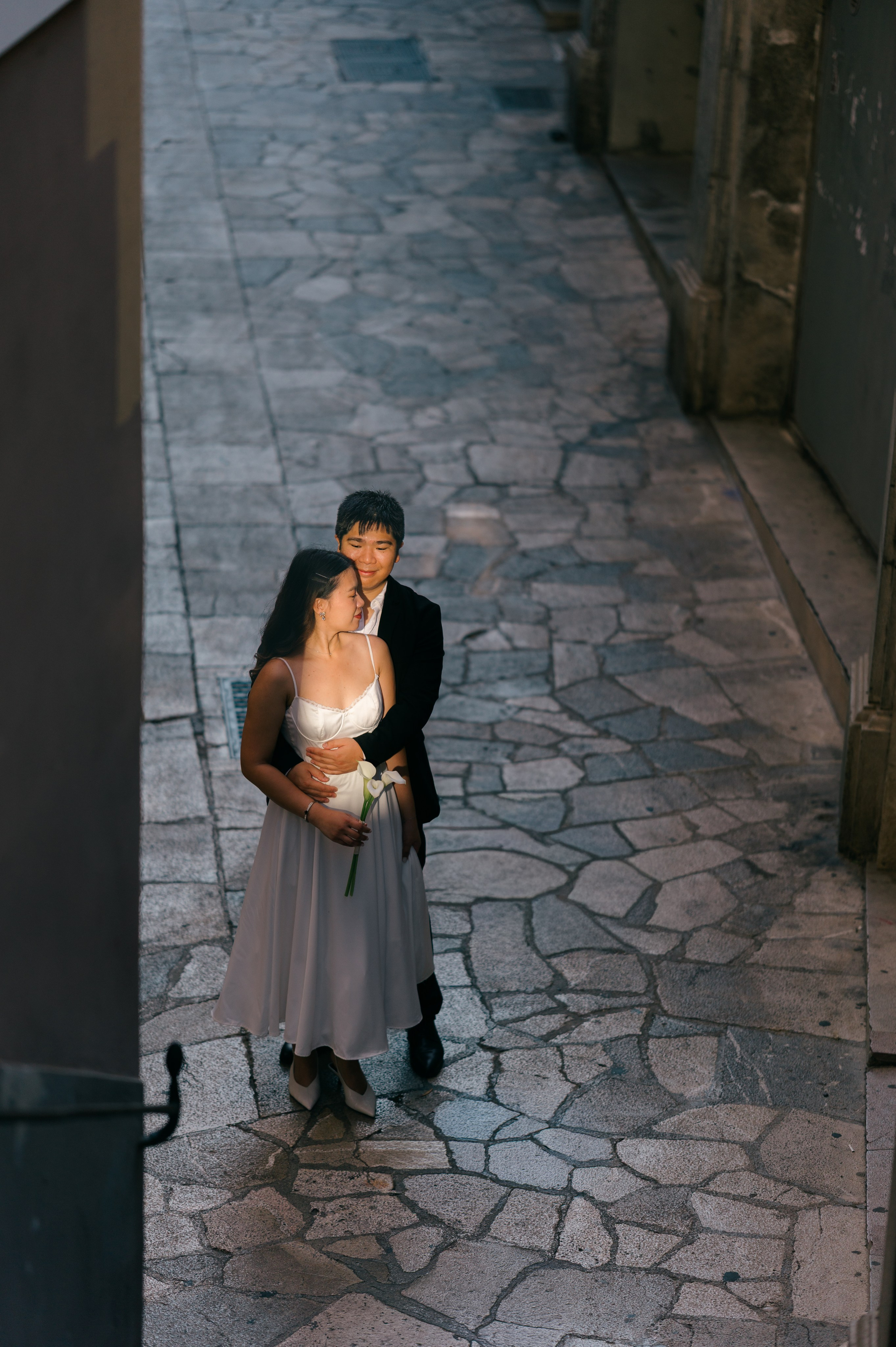 Wedding couple photographed from above in a historic Palma Old Town street