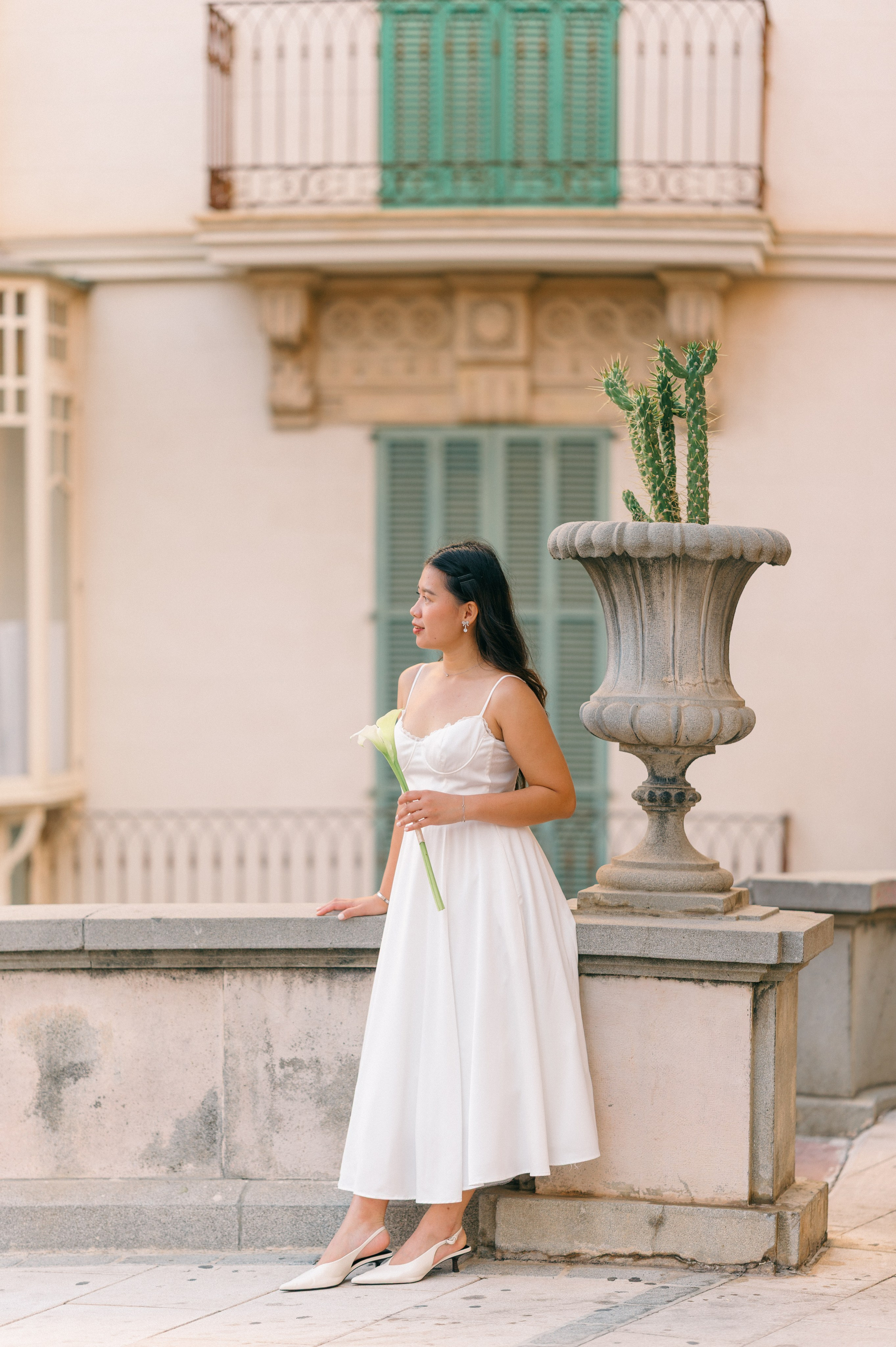 Elegant bridal portrait beside a stone fountain in Palma Old Town