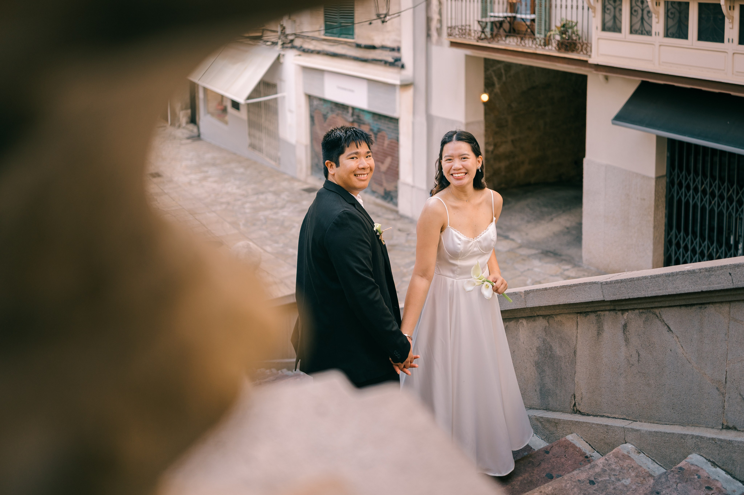 Romantic wedding couple sharing a joyful moment in Palma Old Town