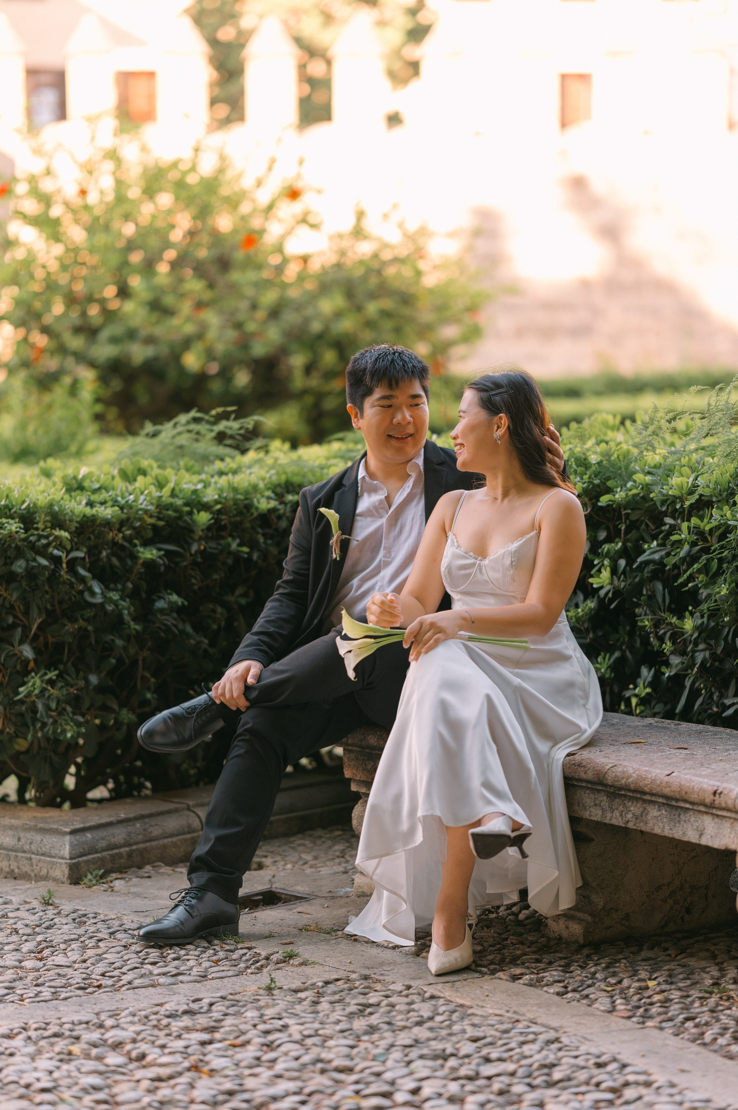 Relaxed wedding couple sitting together in a quiet Palma garden