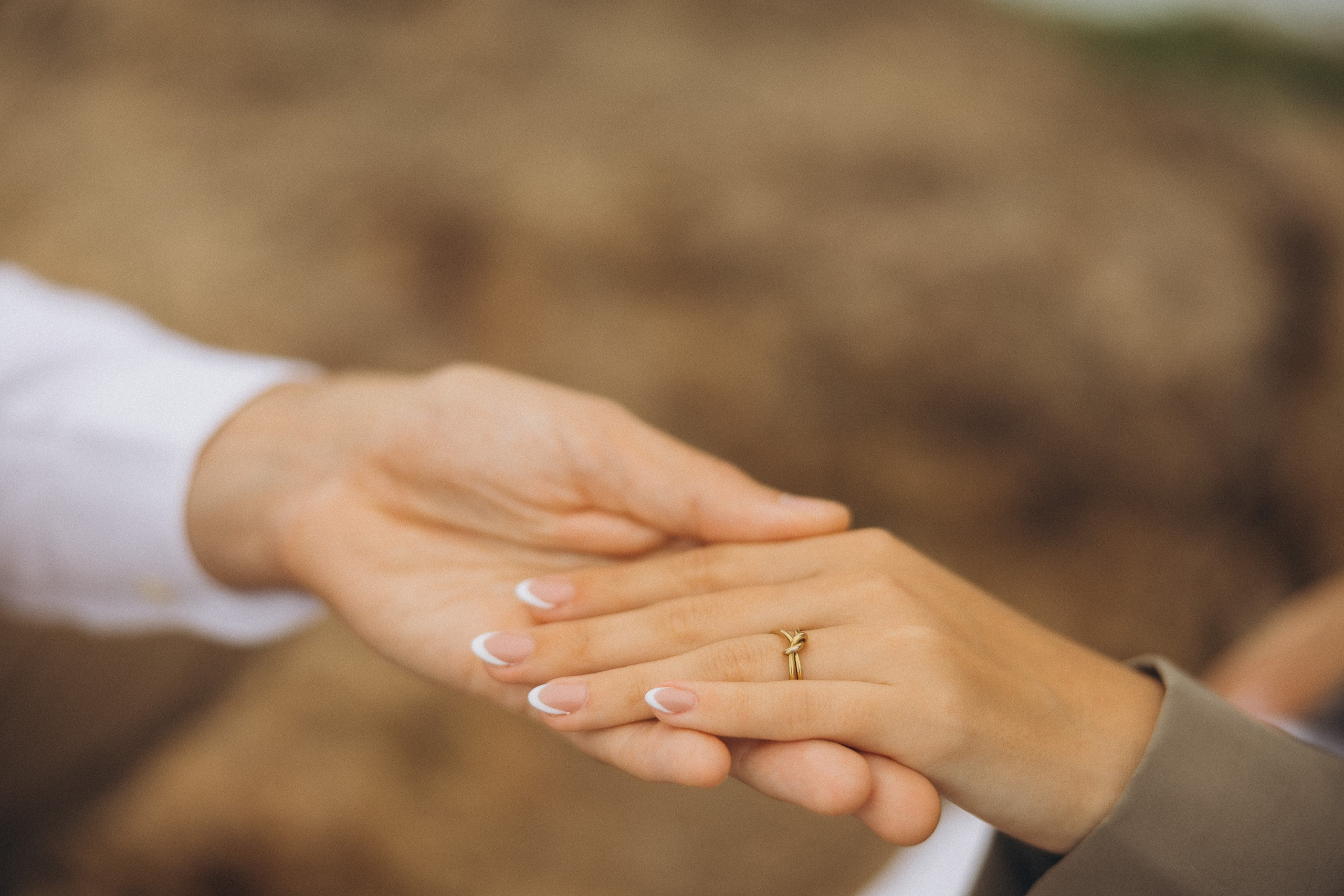 Romantic surprise proposal at sunset on a scenic cliffside in Madeira, Portugal, capturing the emotional moment of love and commitment.
