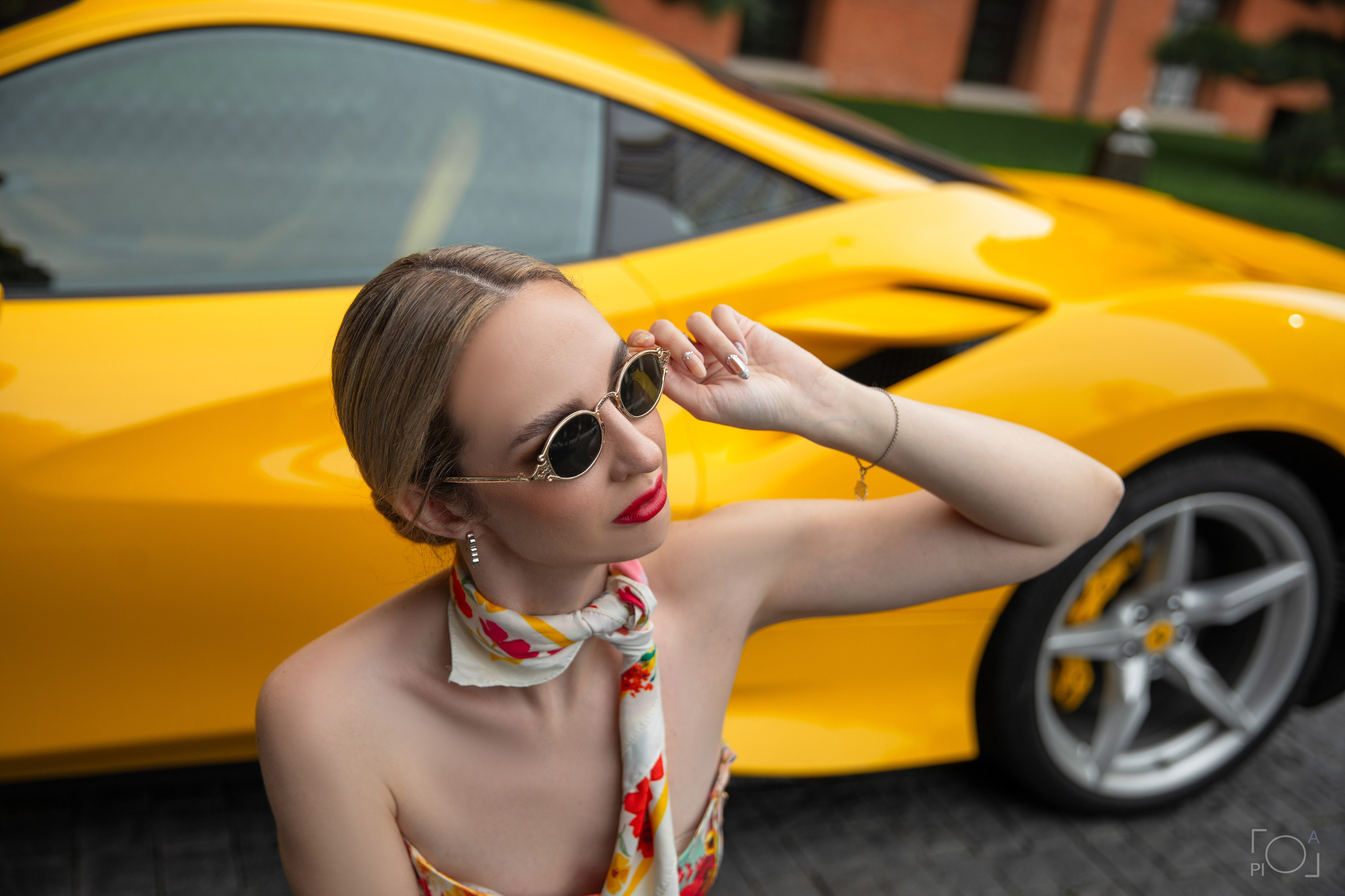 Glamorous photo shoot for a beautiful girl. Girl in sunglasses on the background of yellow sports car. Shanghai