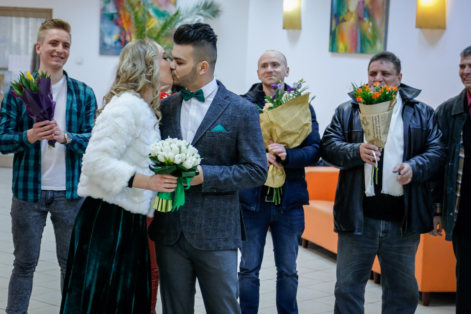 Romantic kiss between the bride and groom in front of the marriage officiant right after taking their civil wedding vows.