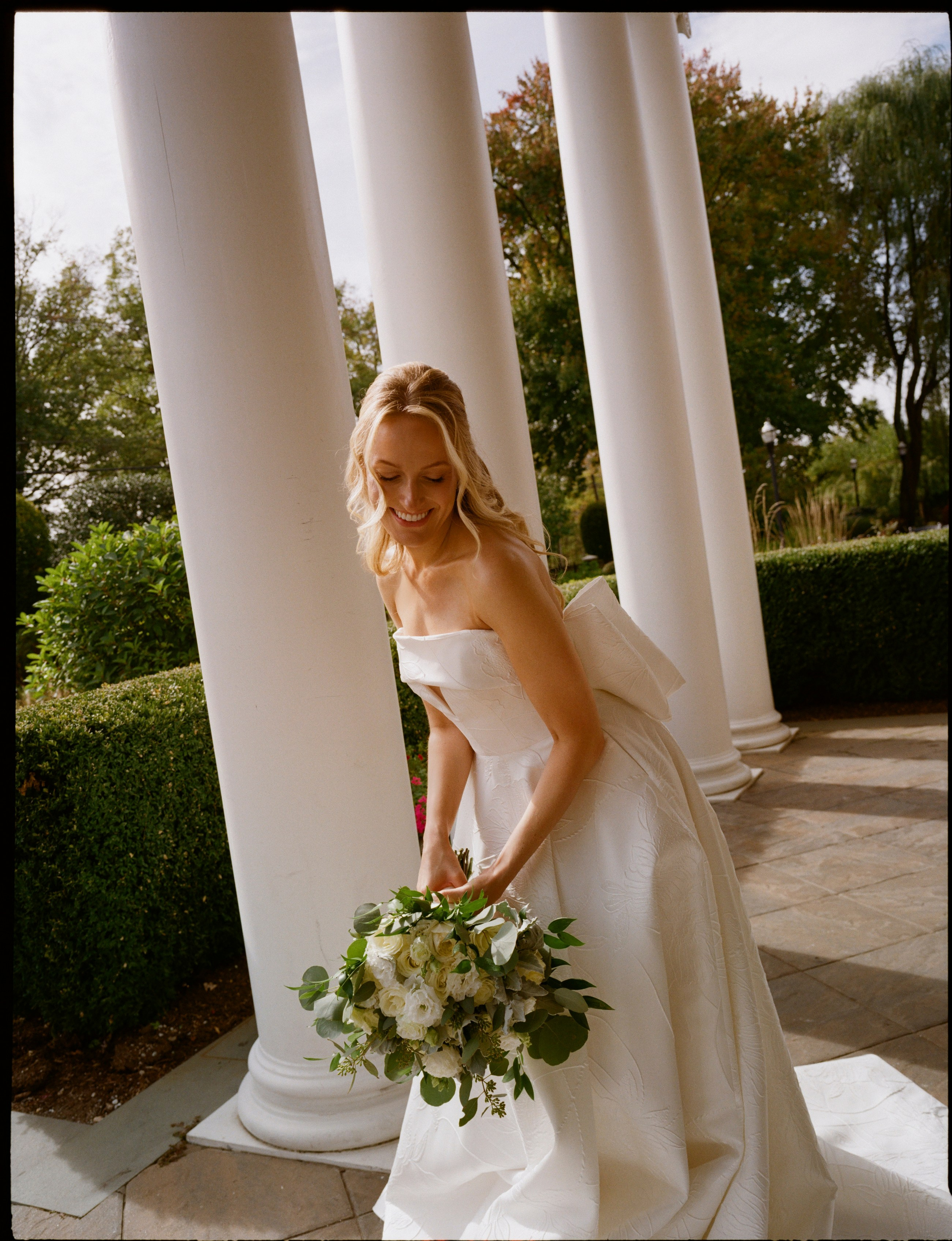 Editorial bridal portrait of Emily holding her bouquet on analog film