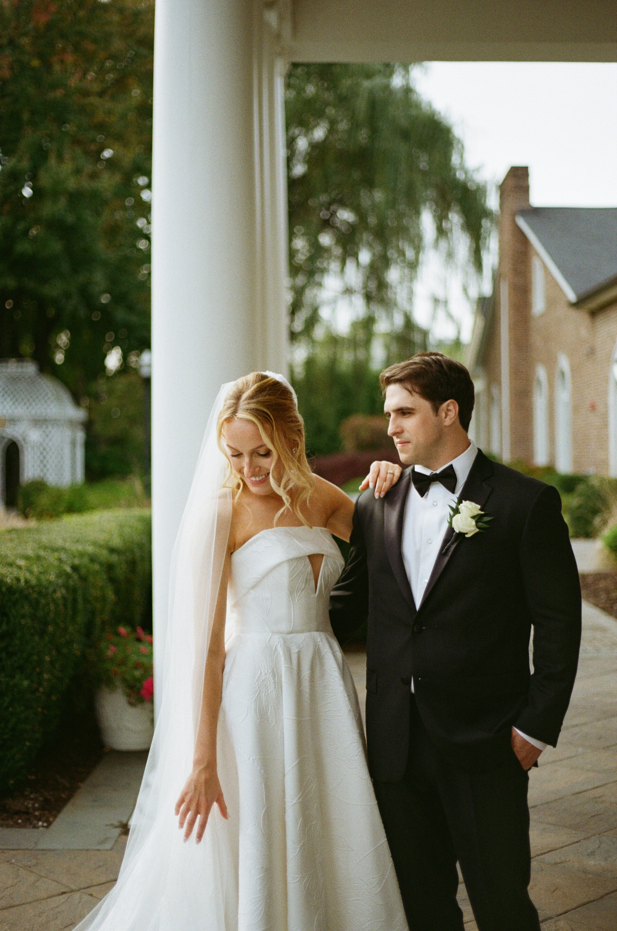Emily and Michael sharing a romantic moment by the columns at The Rockleigh