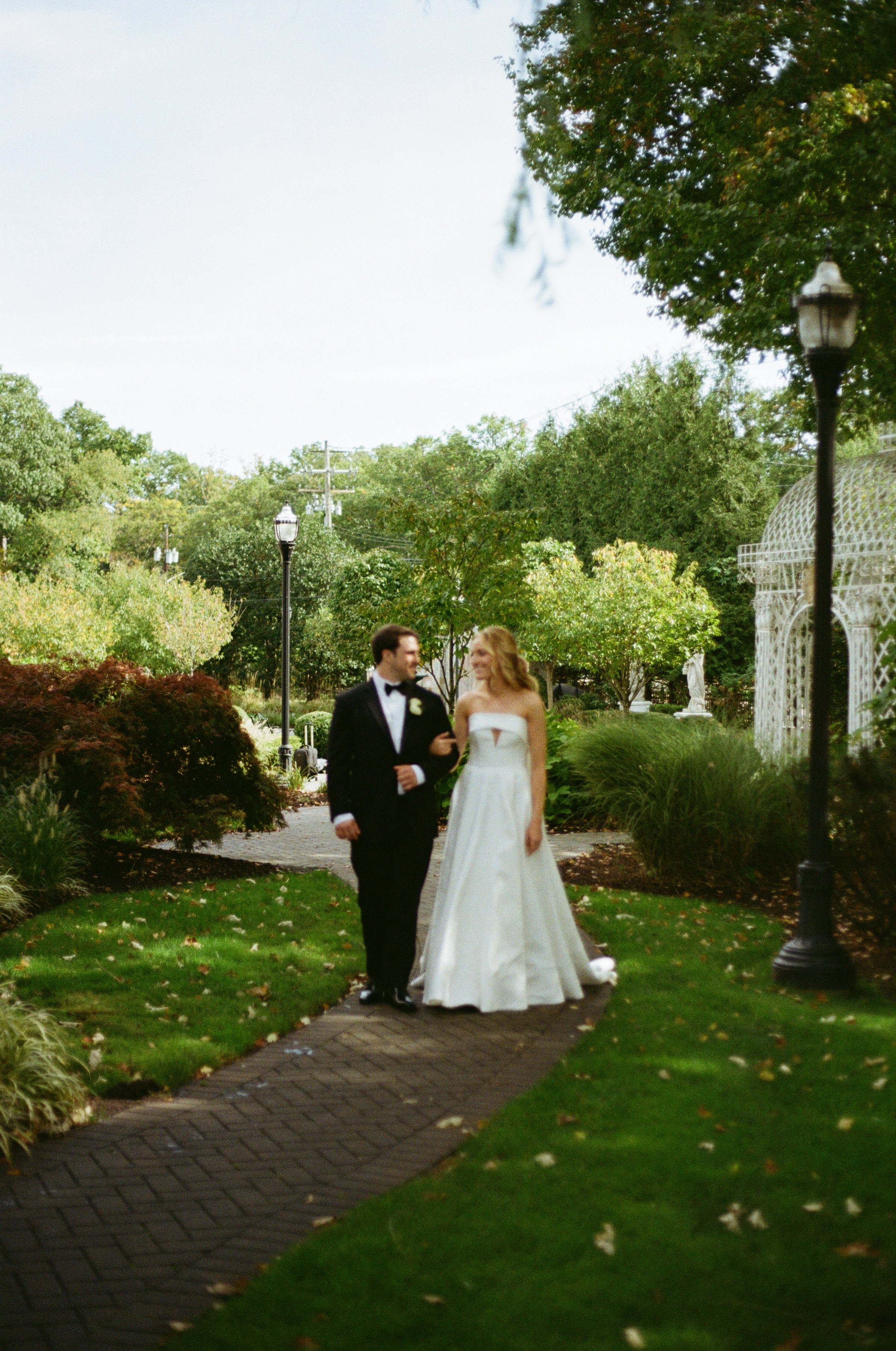 Emily and Michael together on a garden path surrounded by greenery