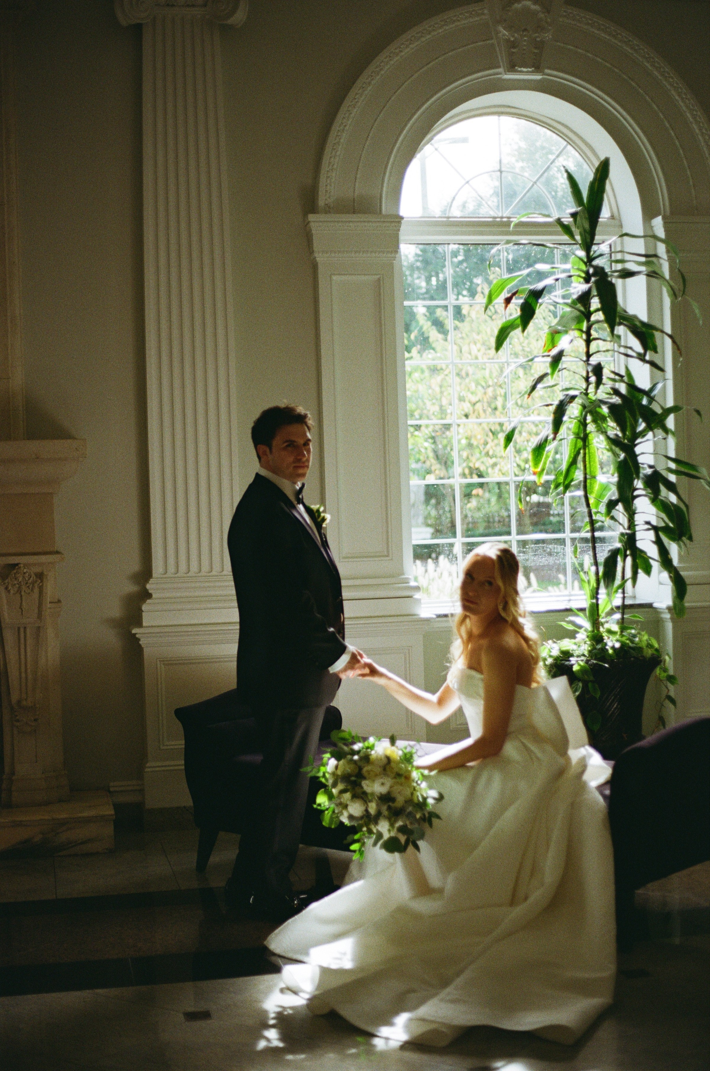 Documentary-style film portrait of Emily and Michael by a sunlit window