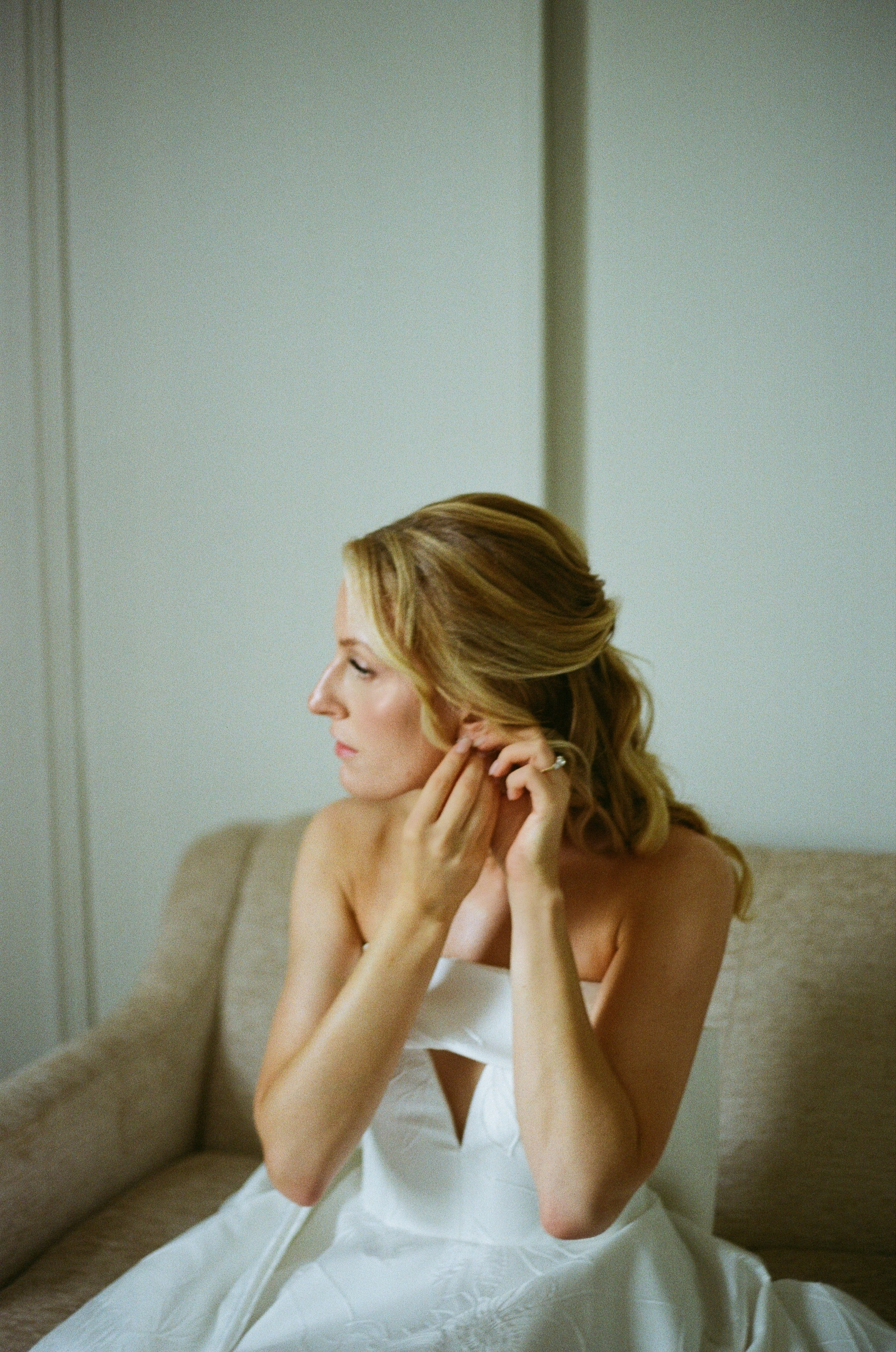 Emily getting ready by the window on her wedding day