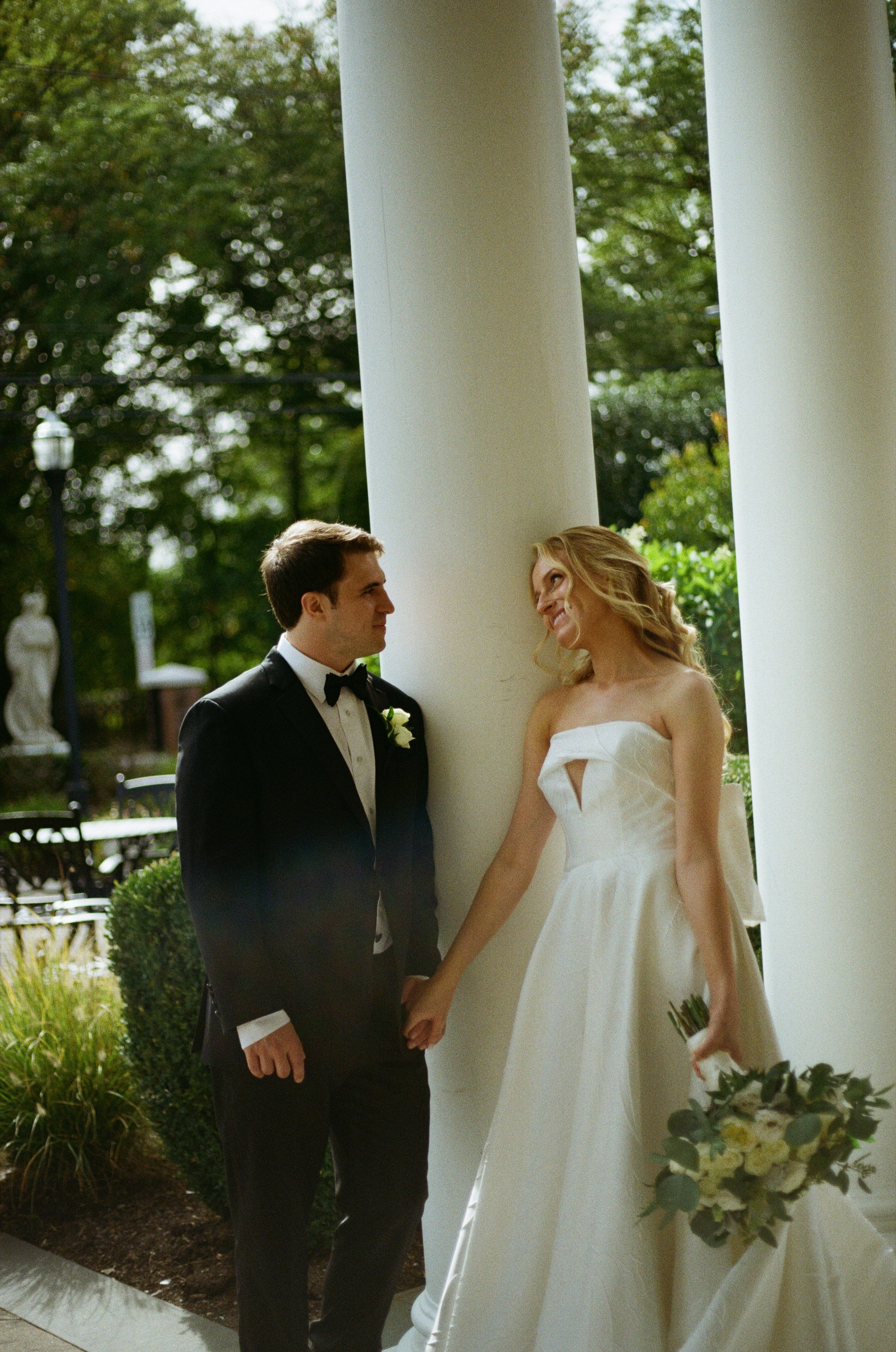 Emily and Michael facing each other during their outdoor wedding portraits