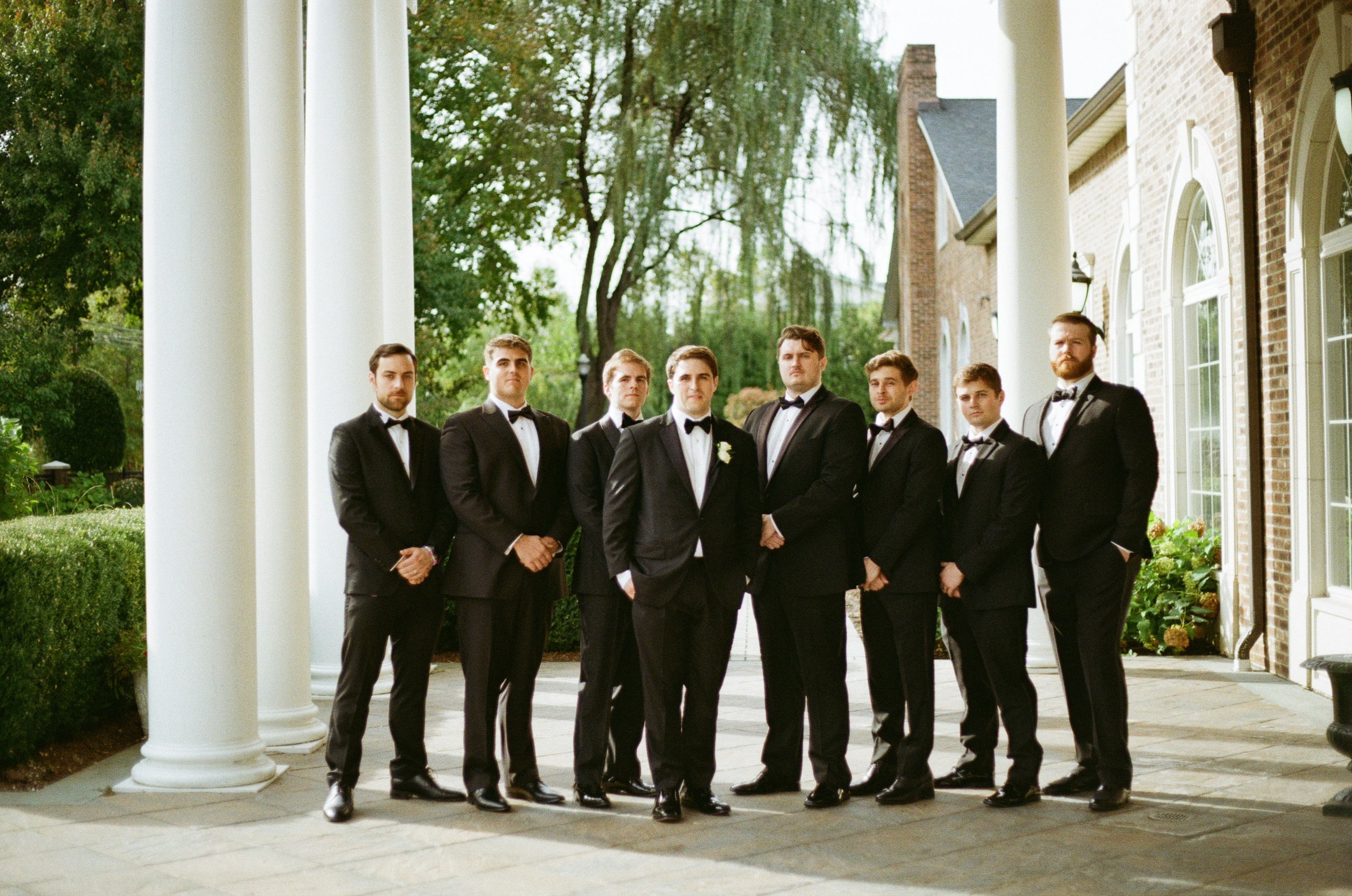 Groom and groomsmen posing outdoors at The Rockleigh wedding venue