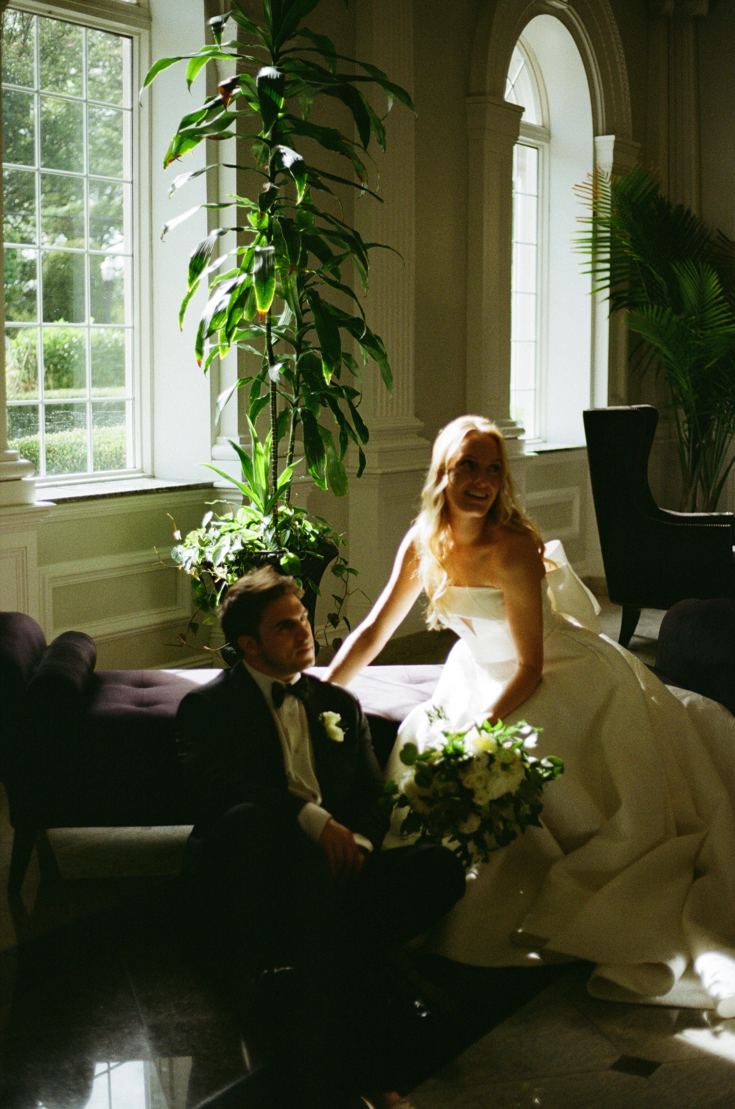 Intimate editorial wedding portrait of the couple in a softly lit room