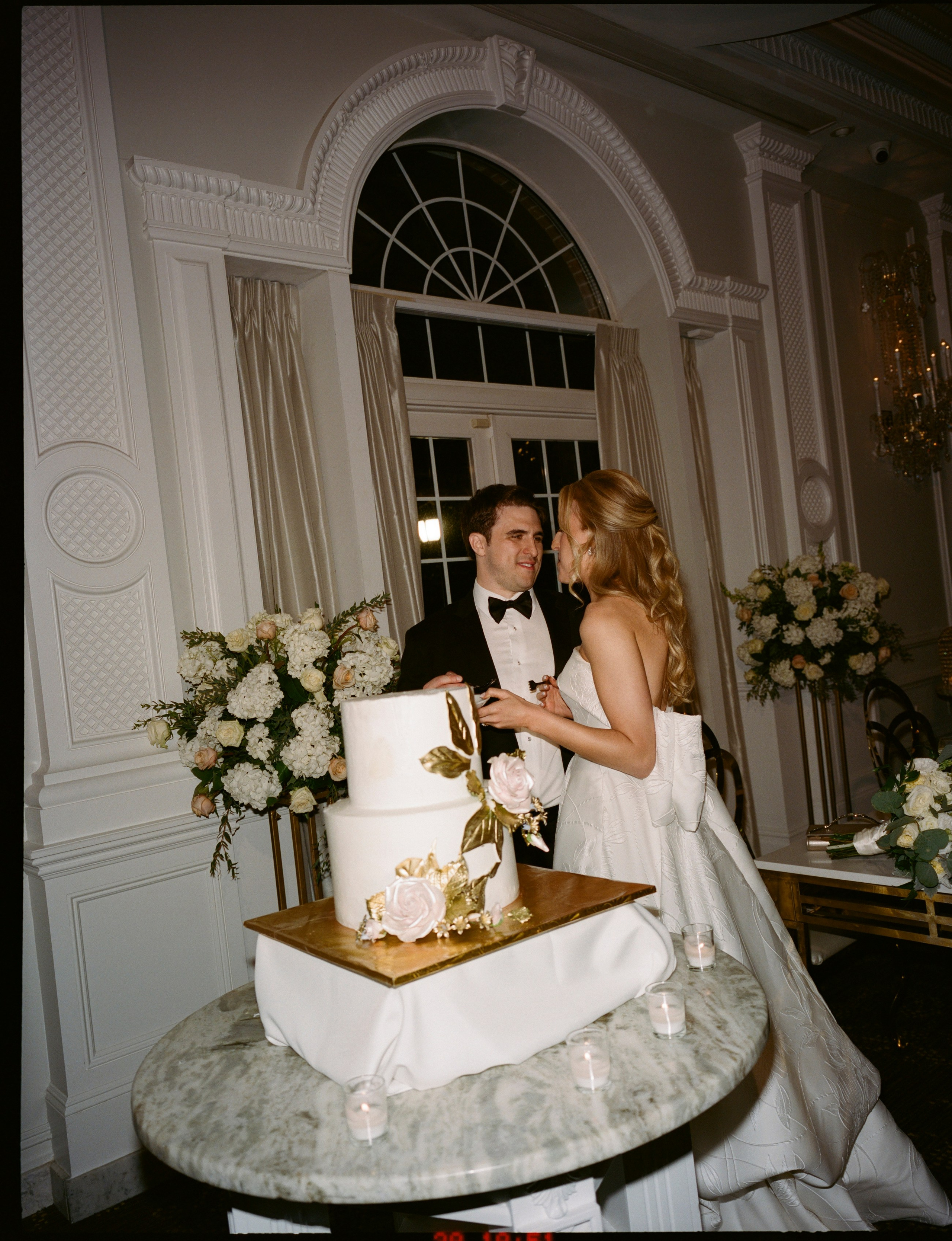 Emily and Michael cutting their wedding cake during the reception
