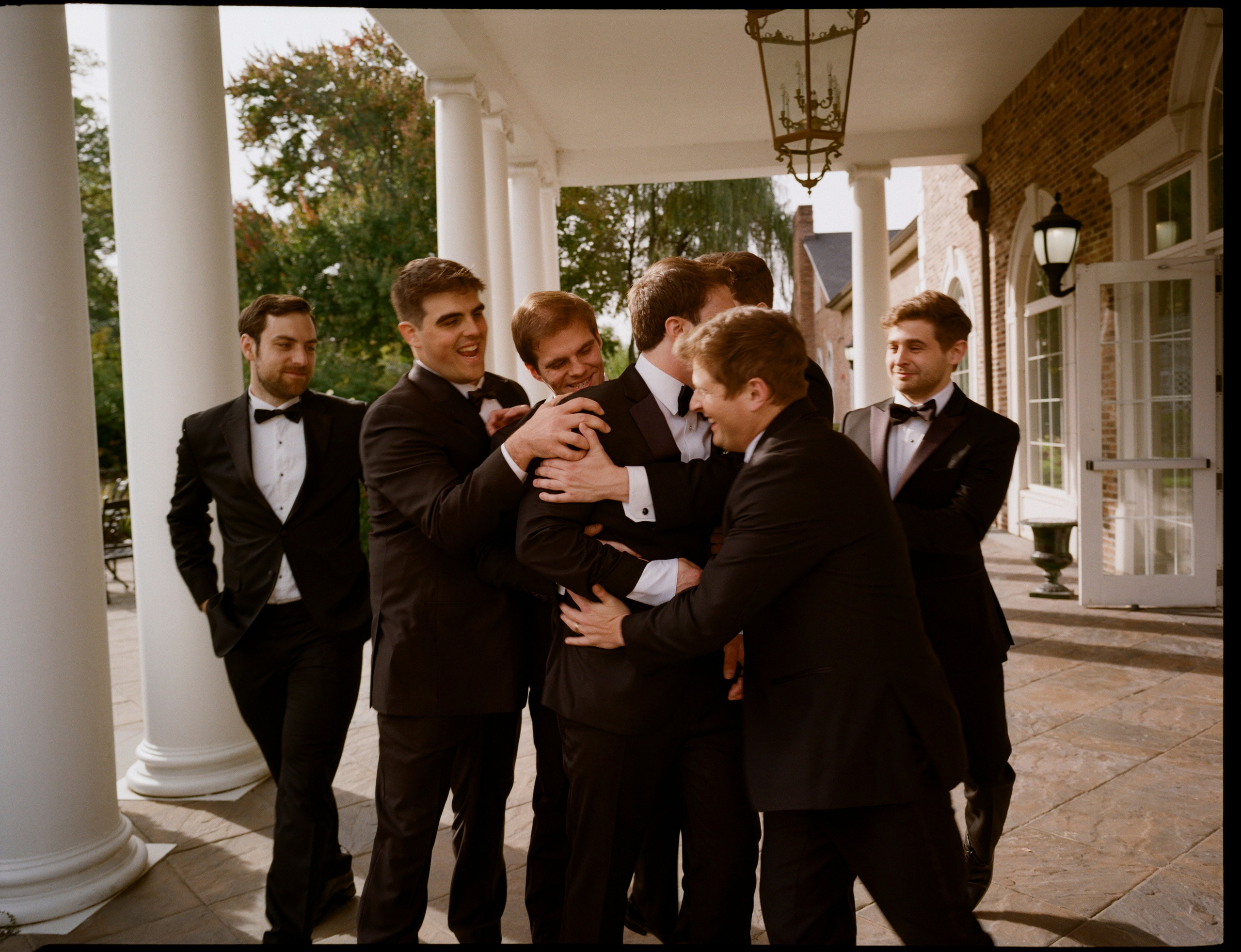 Michael and his groomsmen sharing a candid moment before the wedding