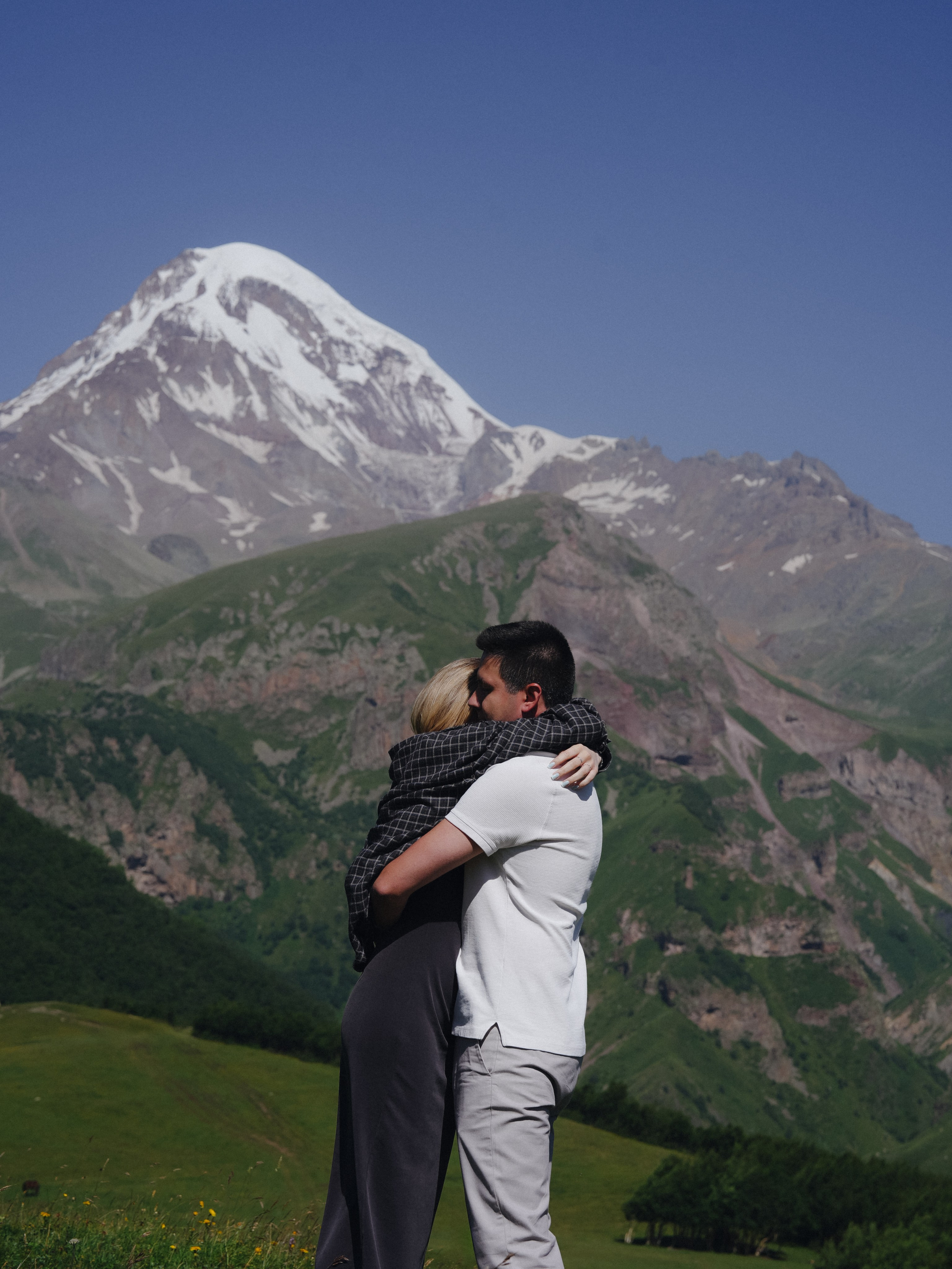 Couple embracing with Mount Kazbek in background