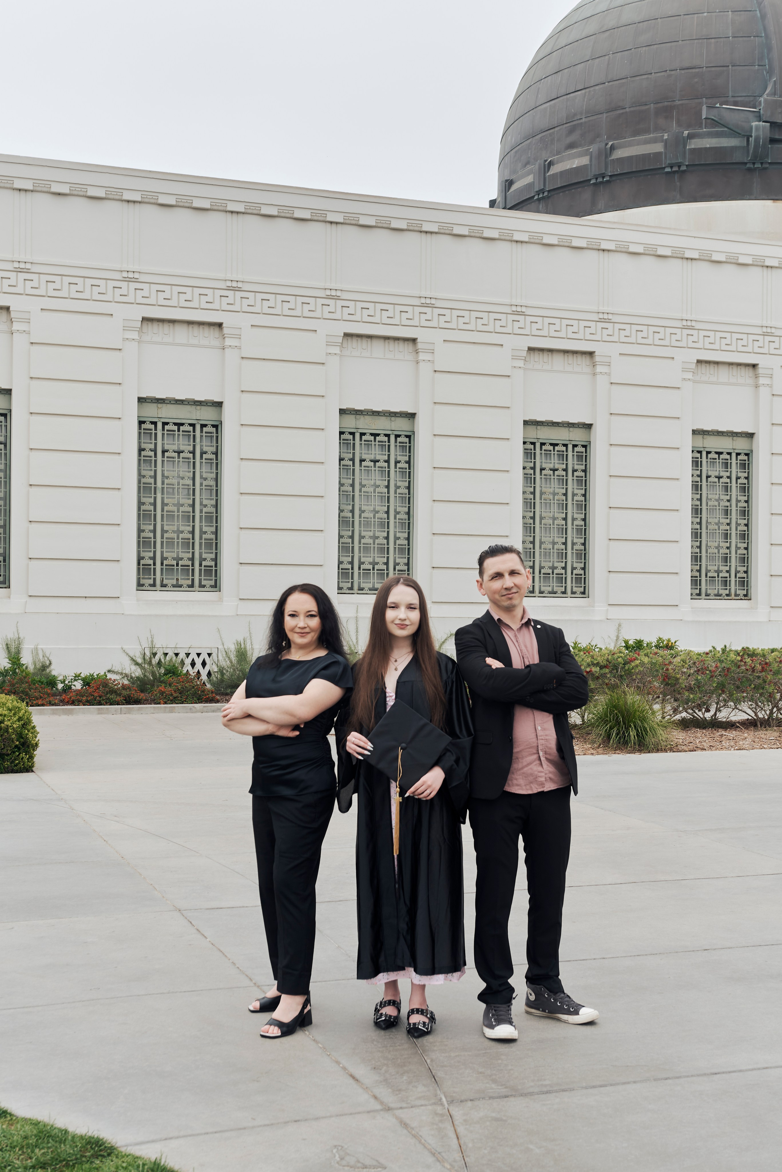 Graduate and best friends celebrating their achievements on a Los Angeles rooftop