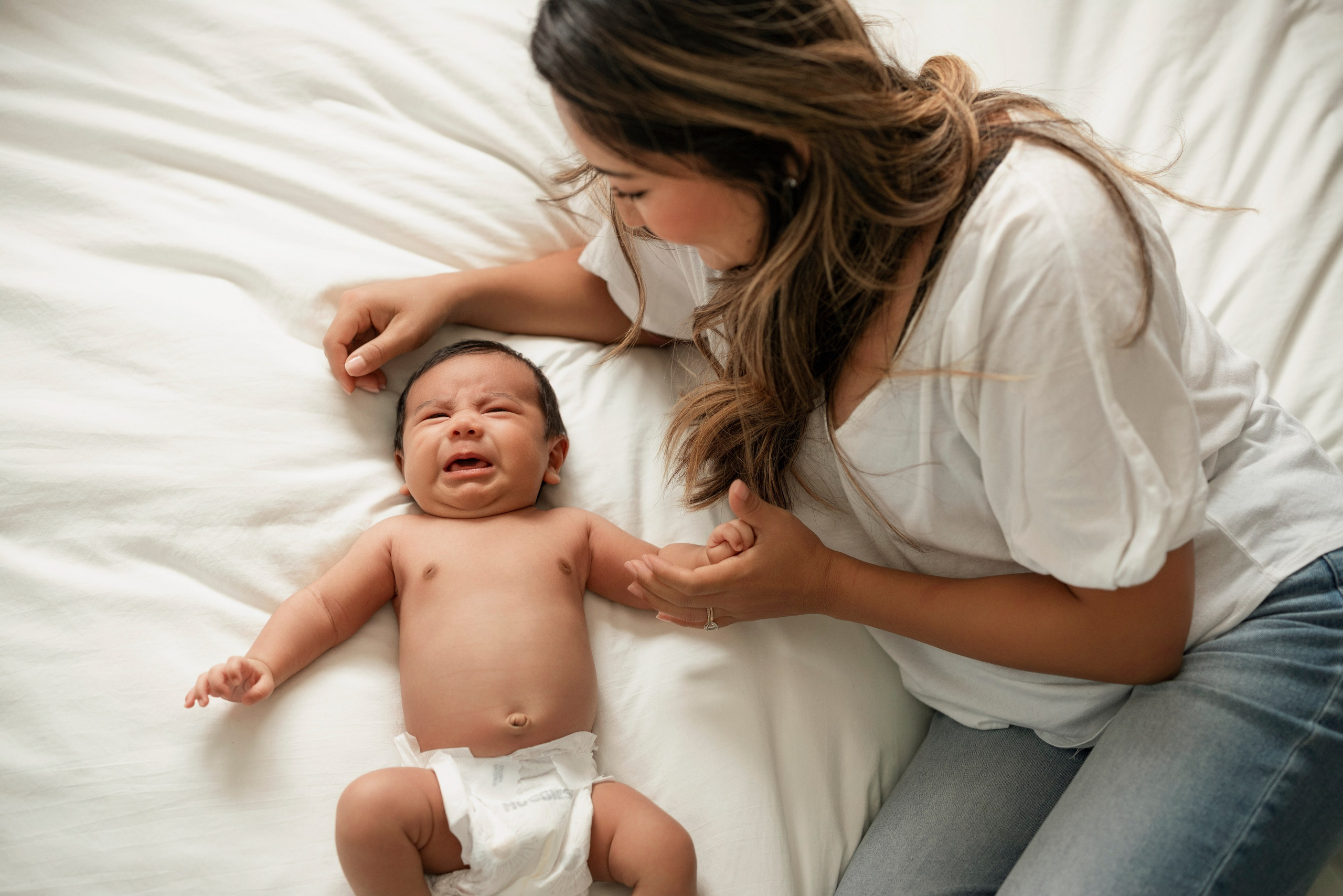 Soft natural light newborn lifestyle photography with parents