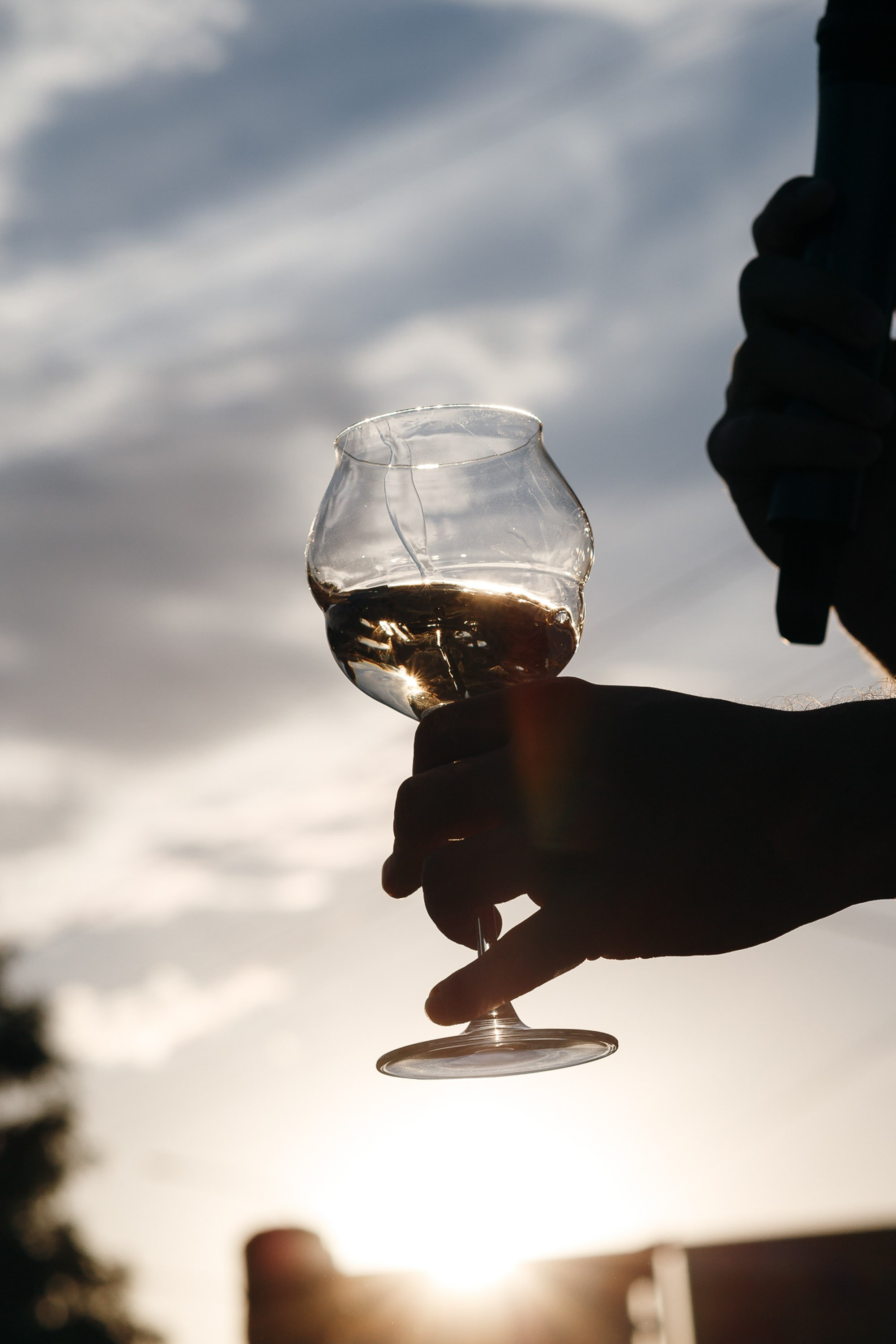 Close-up of cocktail glass at sunset, artistic shot