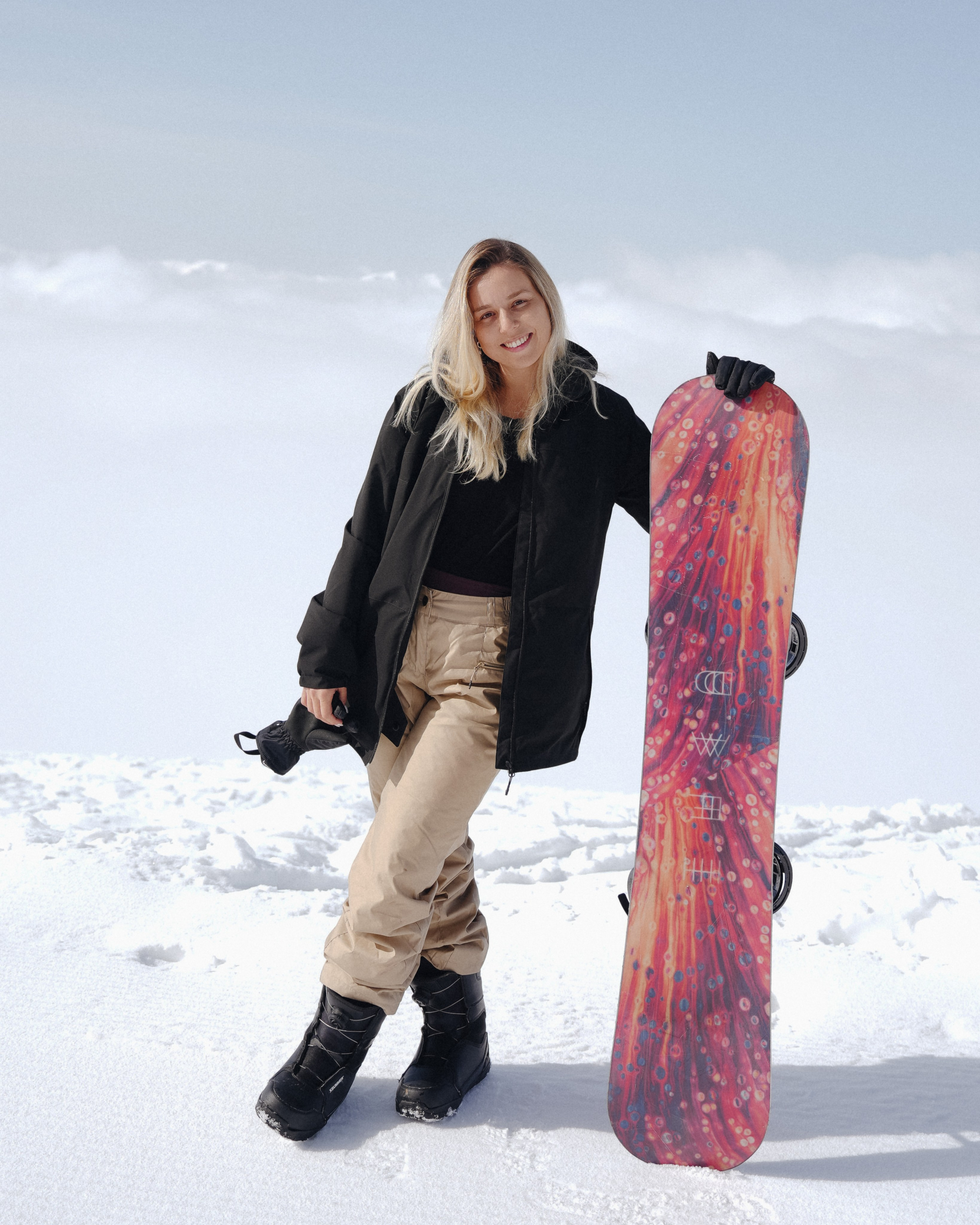 Beautiful young women with snowboard in Gudauri Ski Resort, Georgia